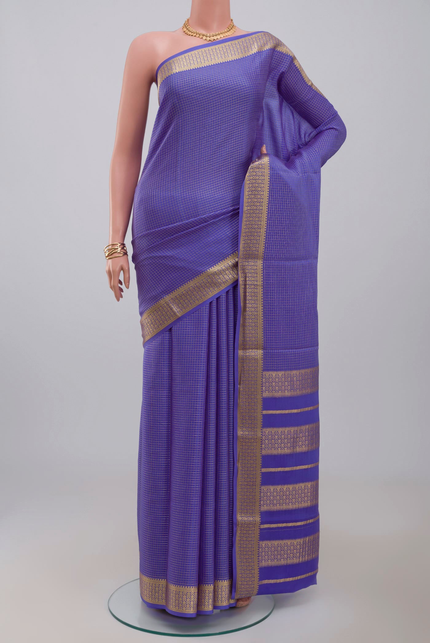 Blue Crepe Saree with Checked design on the body and Zari Border.  displayed on a mannequin