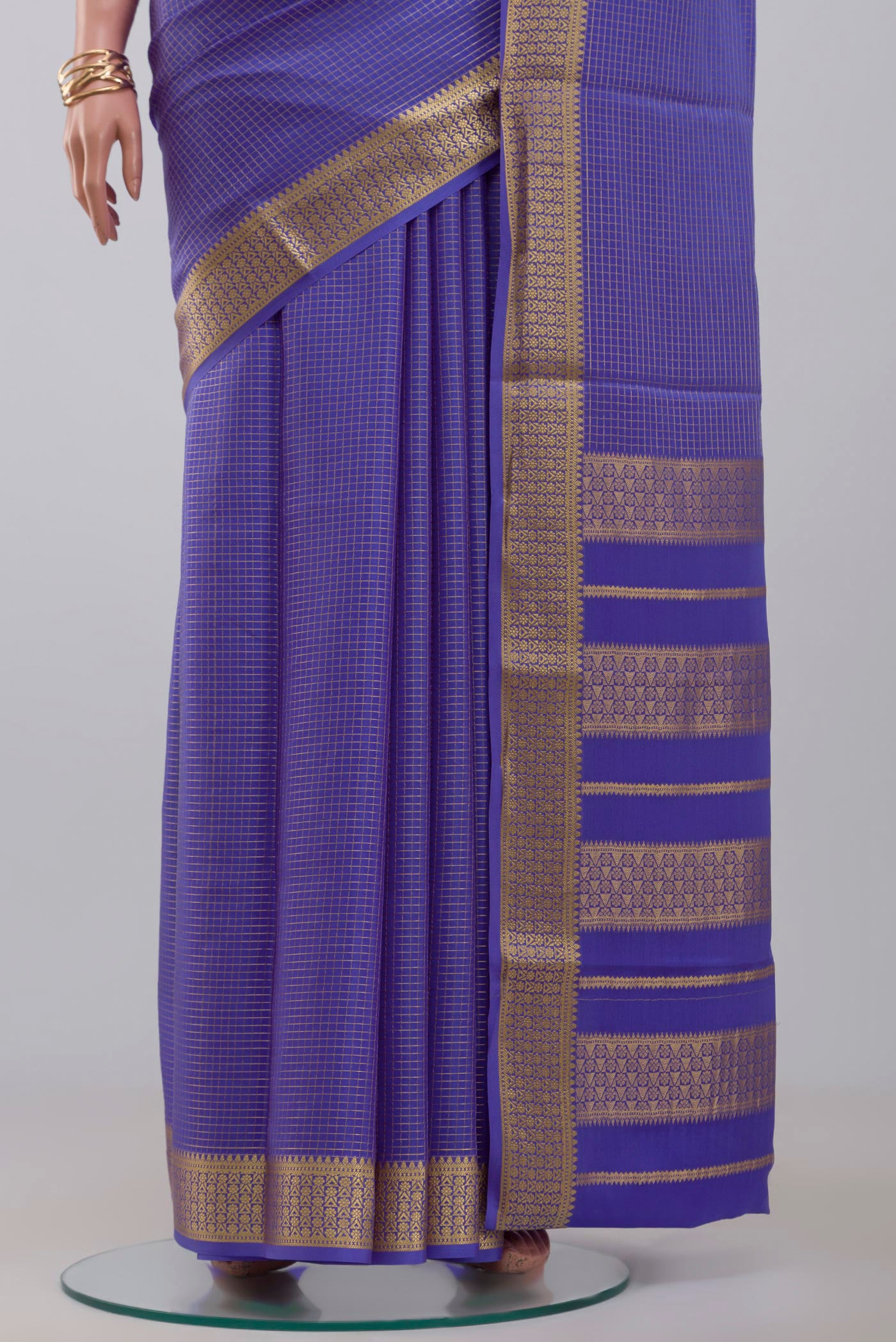 Pleats and pallu of Blue Crepe Saree with Checked design on the body and Zari Border. 
