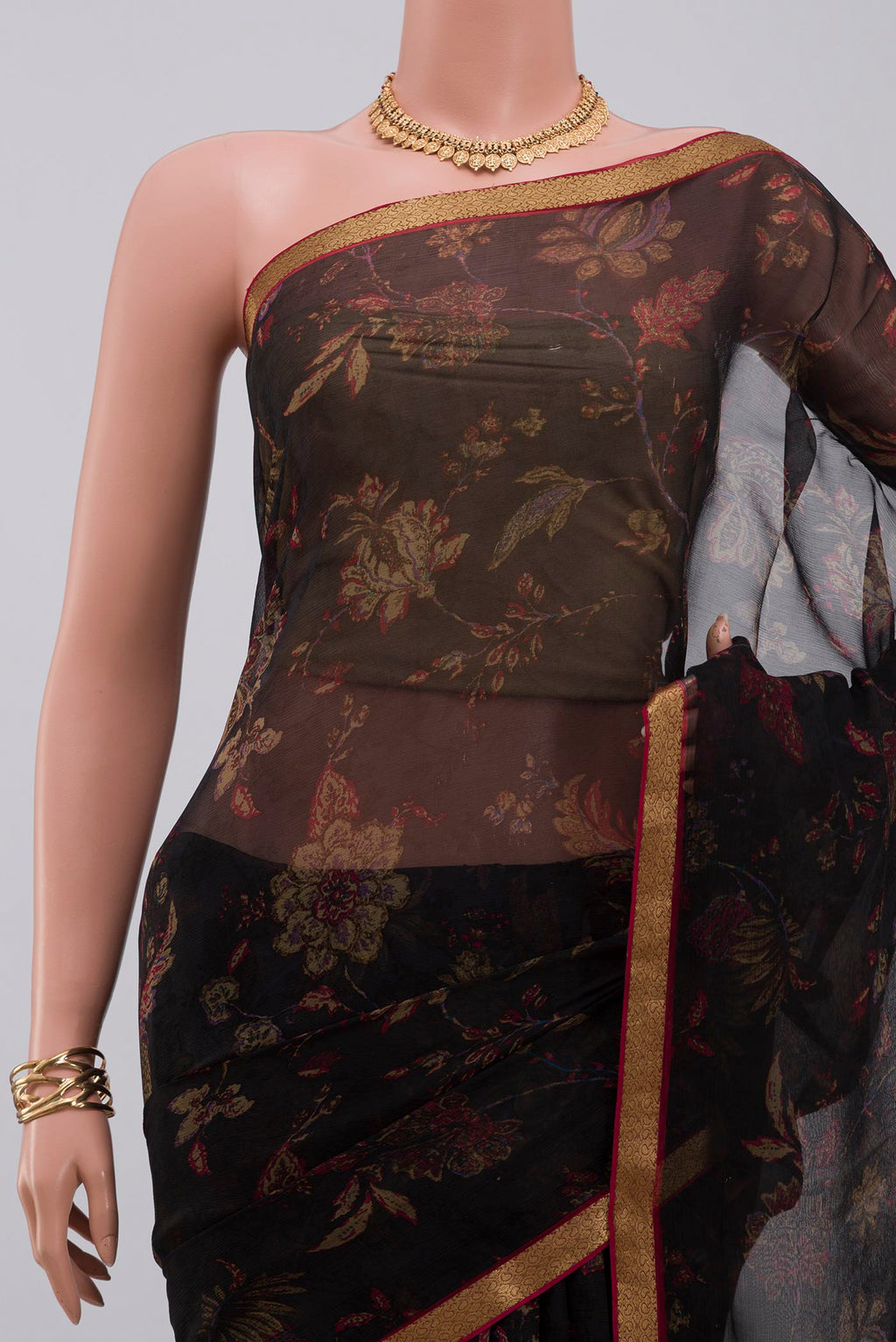 Border image of Black Chiffon Saree with Printed design on the body and Zari Border. 