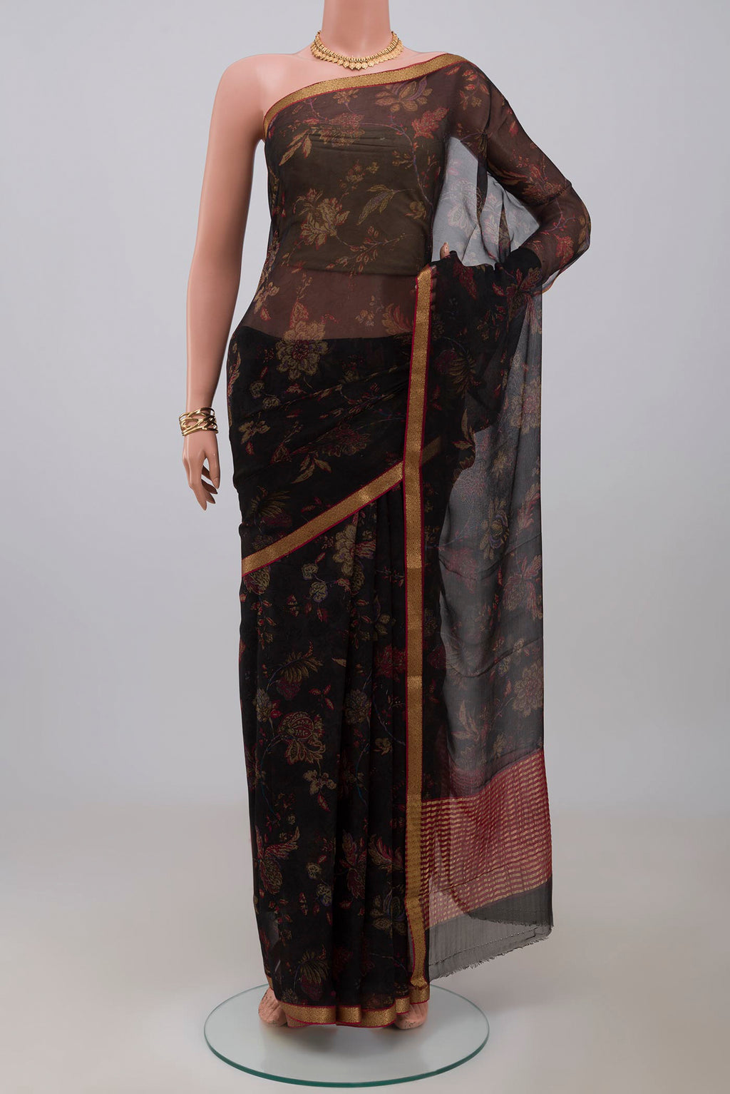 Black Chiffon Saree with Printed design on the body and Zari Border.  displayed on a mannequin