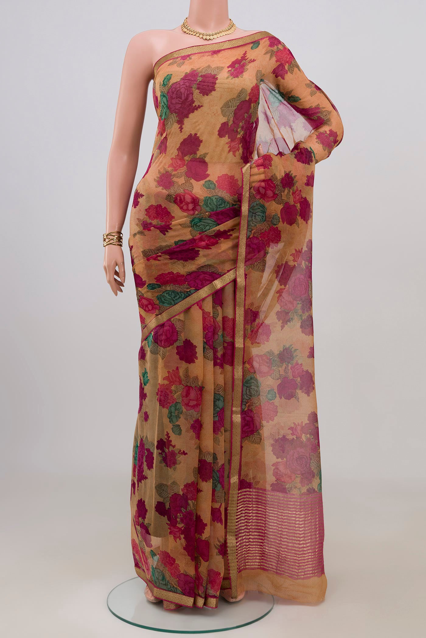 Brown Mysore Chiffon Saree with Floral Print on the body and Zari Border.  displayed on a mannequin