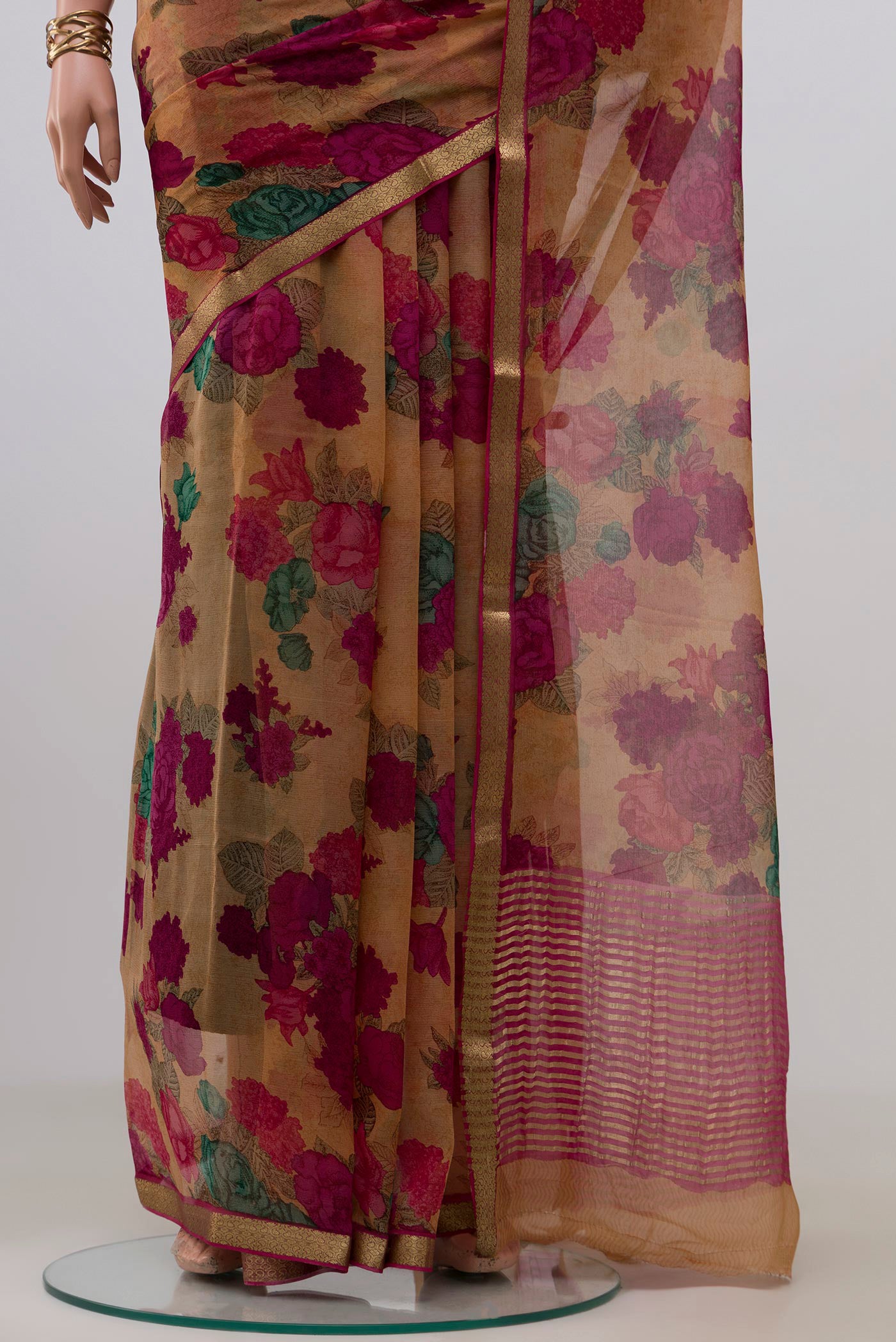 Pleats and pallu of Brown Mysore Chiffon Saree with Floral Print on the body and Zari Border. 