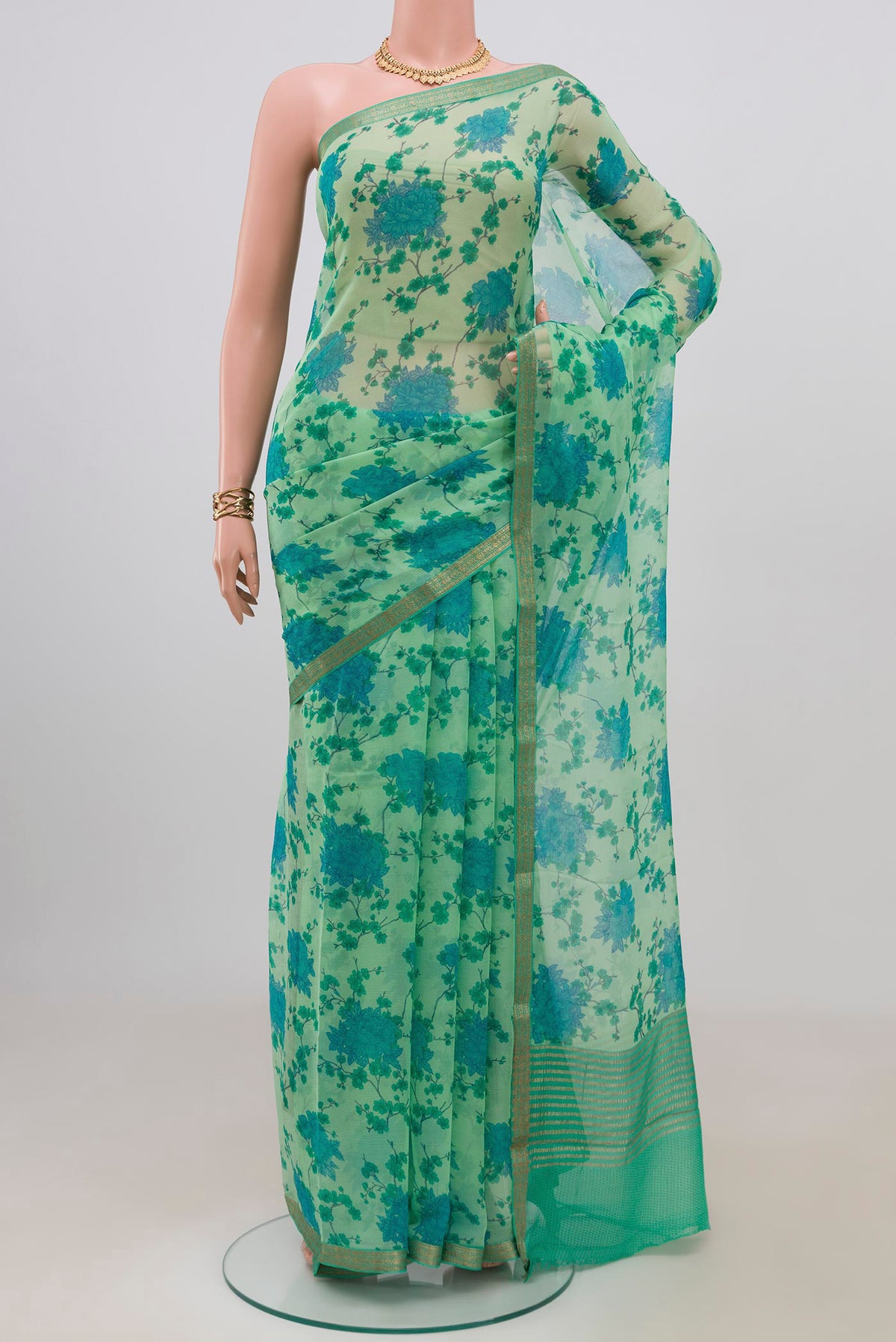 Mint Green Mysore Chiffon Saree with Floral Print on the body and Zari Border.  displayed on a mannequin