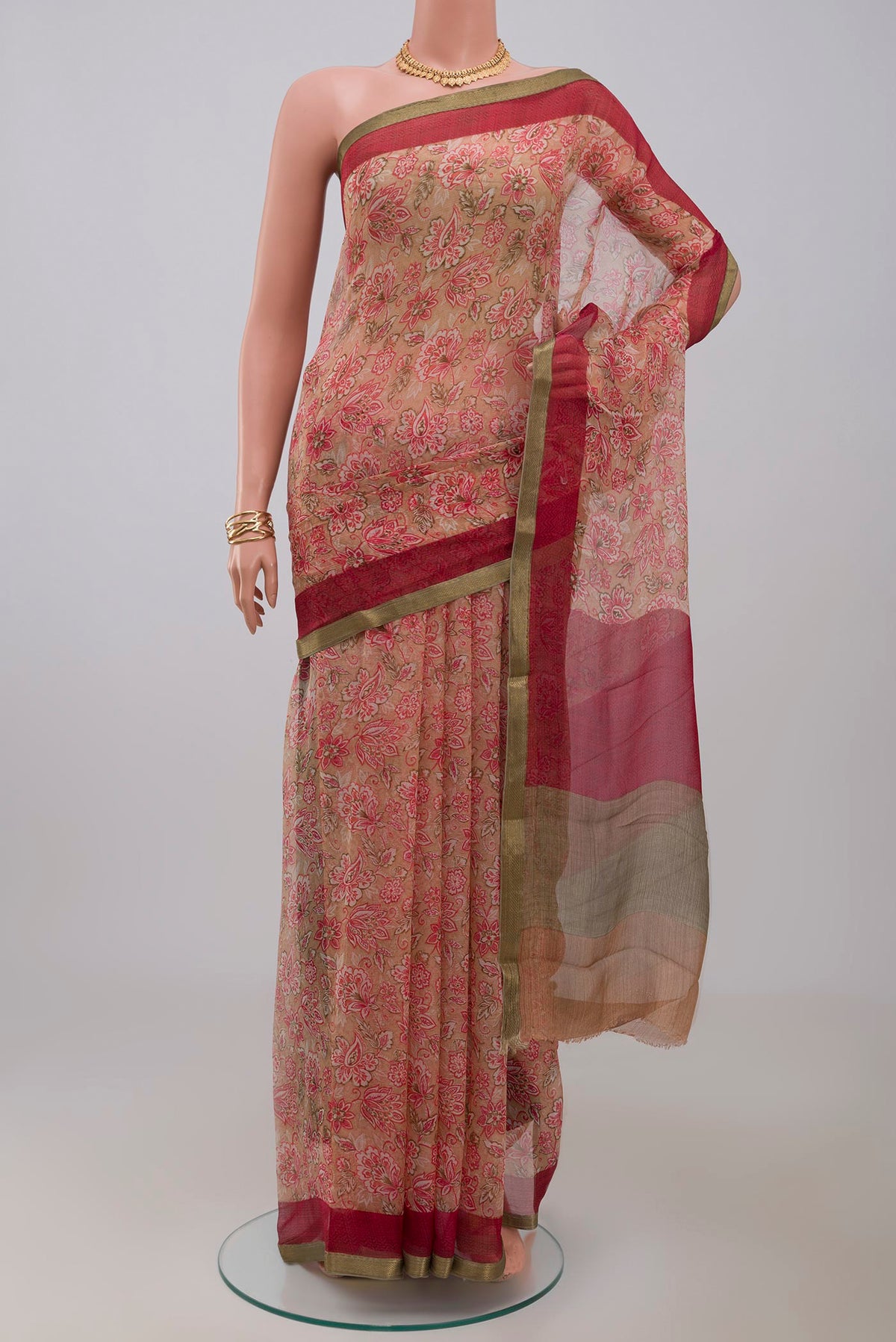Beige Chiffon Saree with Printed design on the body and Zari Border.  displayed on a mannequin