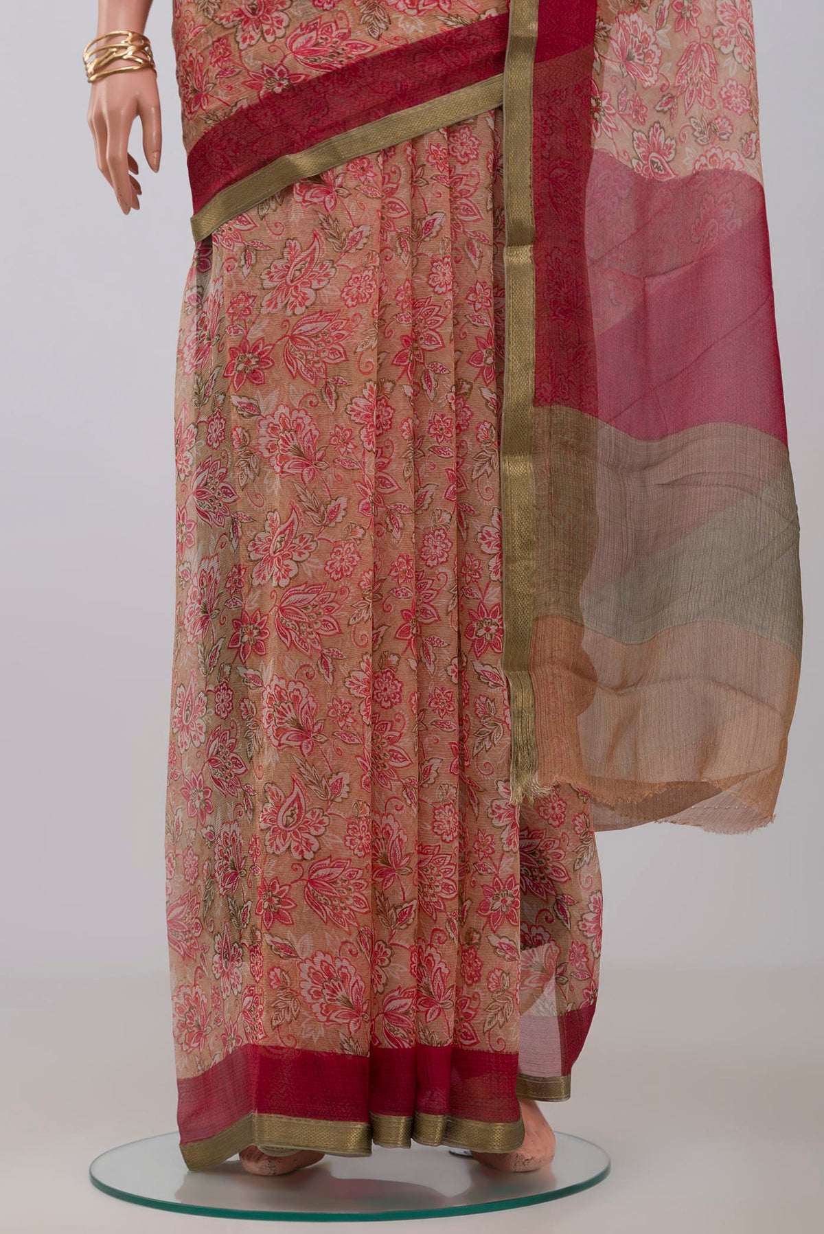 Pleats and pallu of Beige Chiffon Saree with Printed design on the body and Zari Border. 