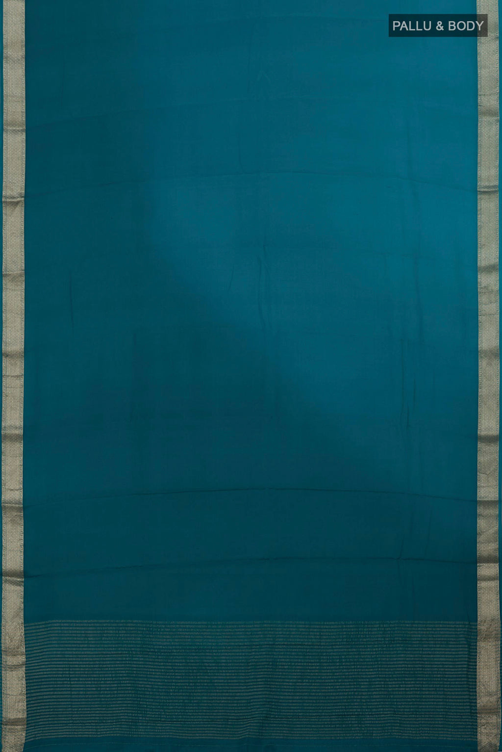 Flat view of Blue Mysore Chiffon Saree with Ombre design on the body and Zari Border. 