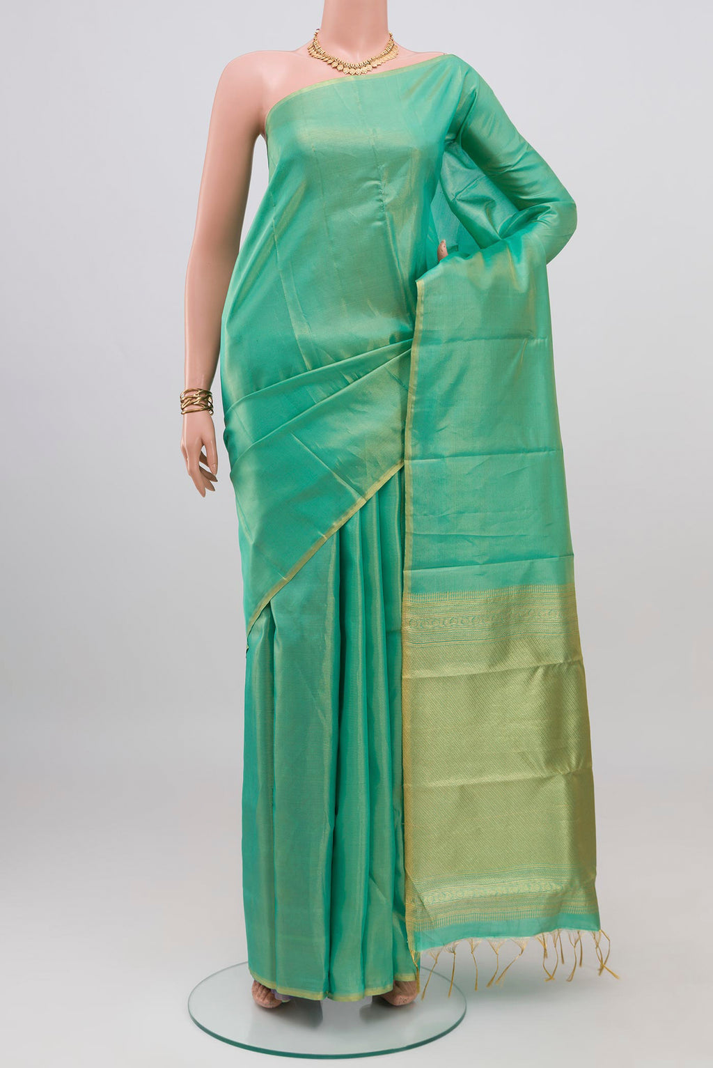 Sea Green Soft Silk Saree with Plain Body and Zari Border.  displayed on a mannequin
