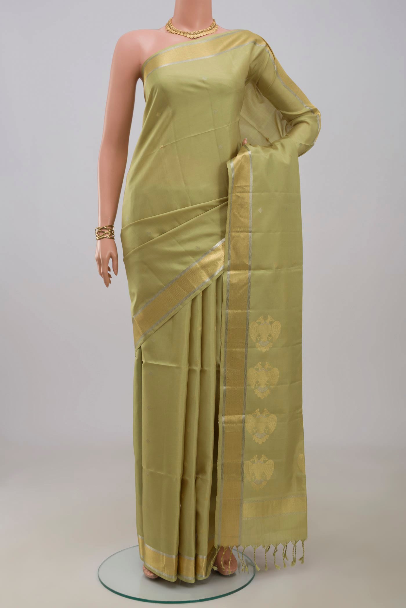 Beige Soft Silk Saree with Zari Butta on the body and Zari Border.  displayed on a mannequin