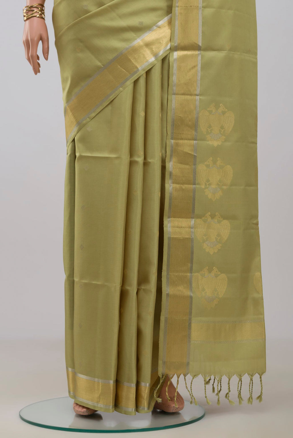 Pleats and pallu of Beige Soft Silk Saree with Zari Butta on the body and Zari Border. 