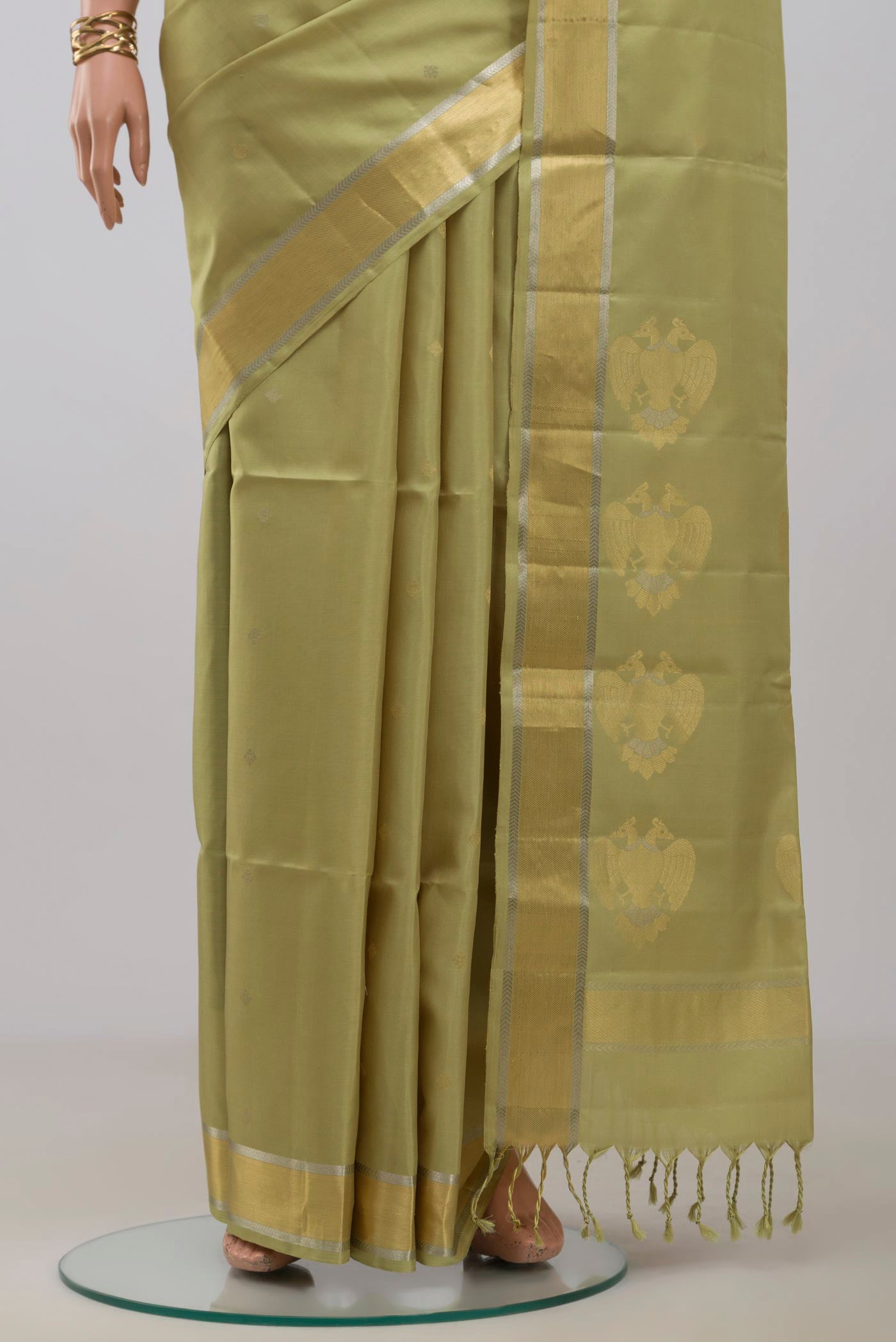 Pleats and pallu of Beige Soft Silk Saree with Zari Butta on the body and Zari Border. 