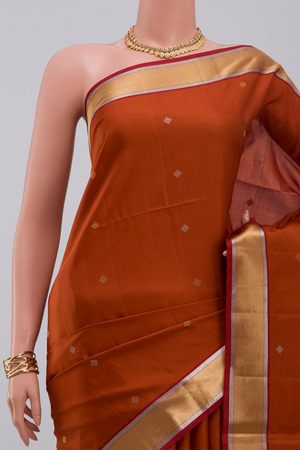 Border image of Rust Soft Silk Saree with Zari Butta on the body and Zari Border. 