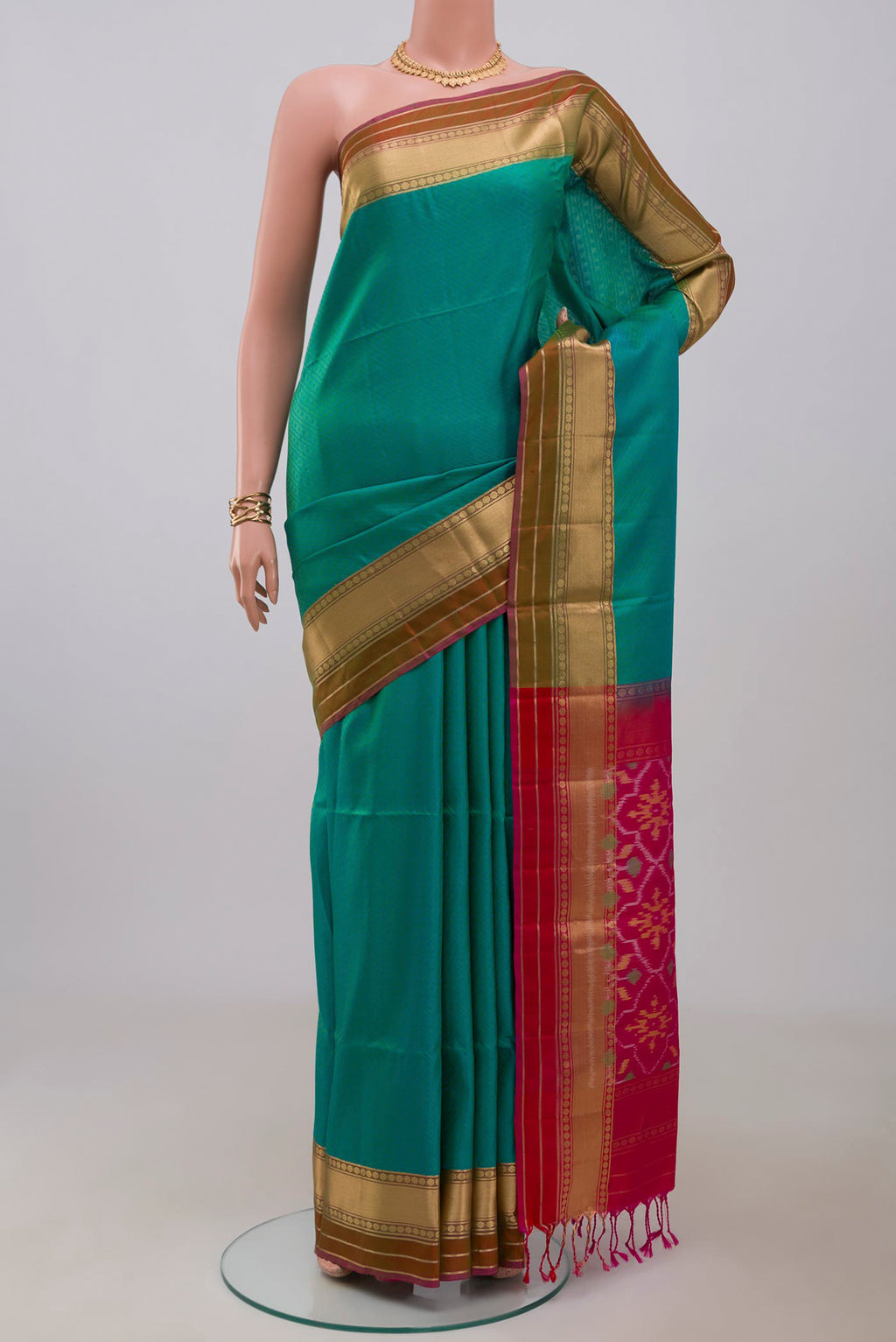 Green Soft Silk Saree with Jacquard design on the body and Zari Border.  displayed on a mannequin