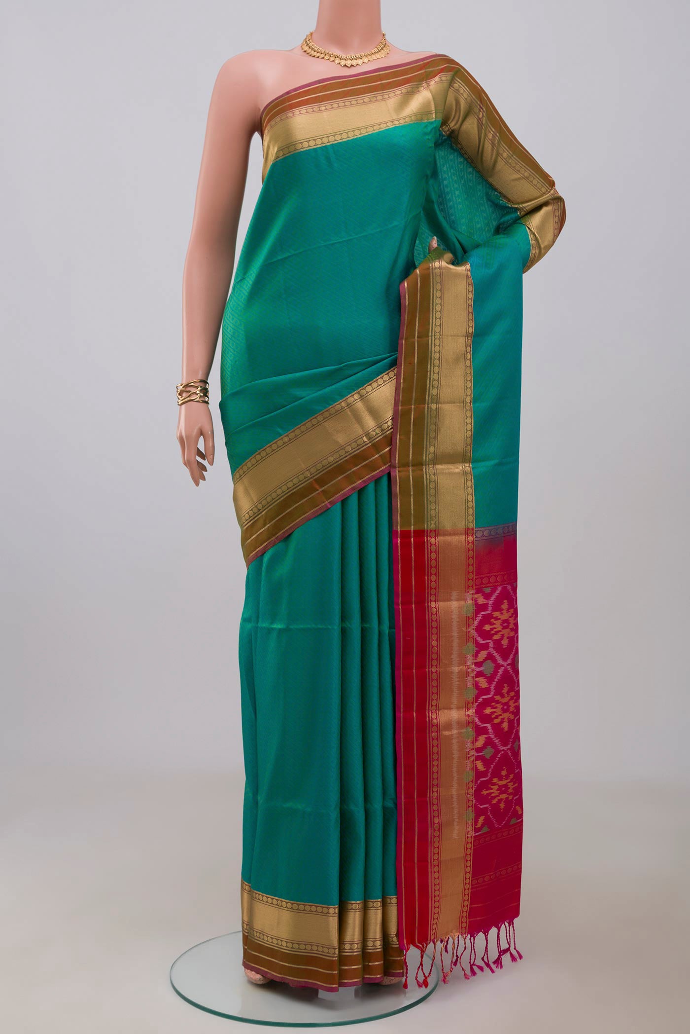 Green Soft Silk Saree with Jacquard design on the body and Zari Border.  displayed on a mannequin