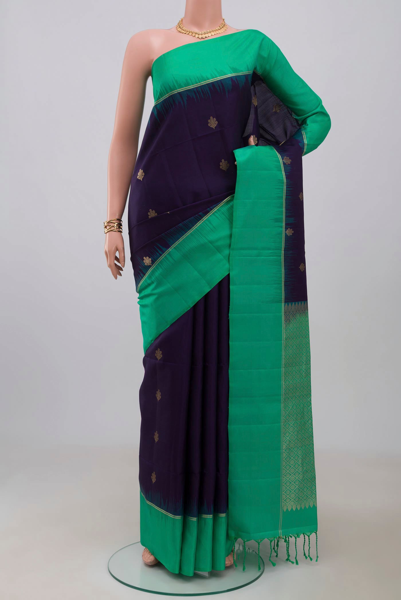 Blue Soft Silk Saree with Zari Butta on the body and Thin Zari Line.  displayed on a mannequin