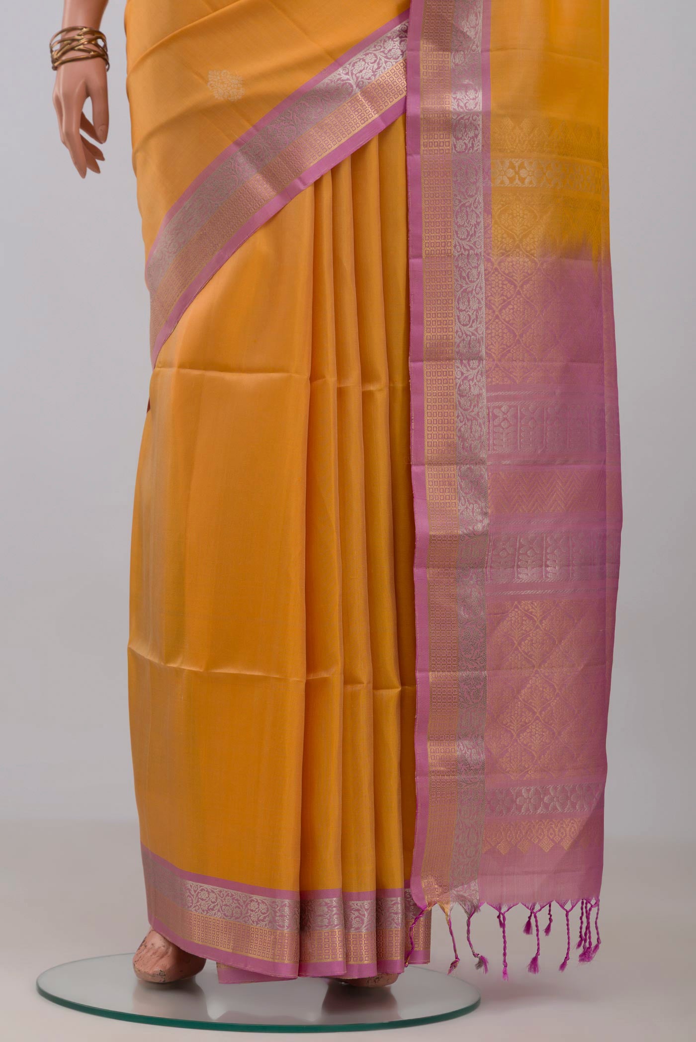 Pleats and pallu of Yellow Soft Silk Saree with Zari Butta on the body and Zari Border. 