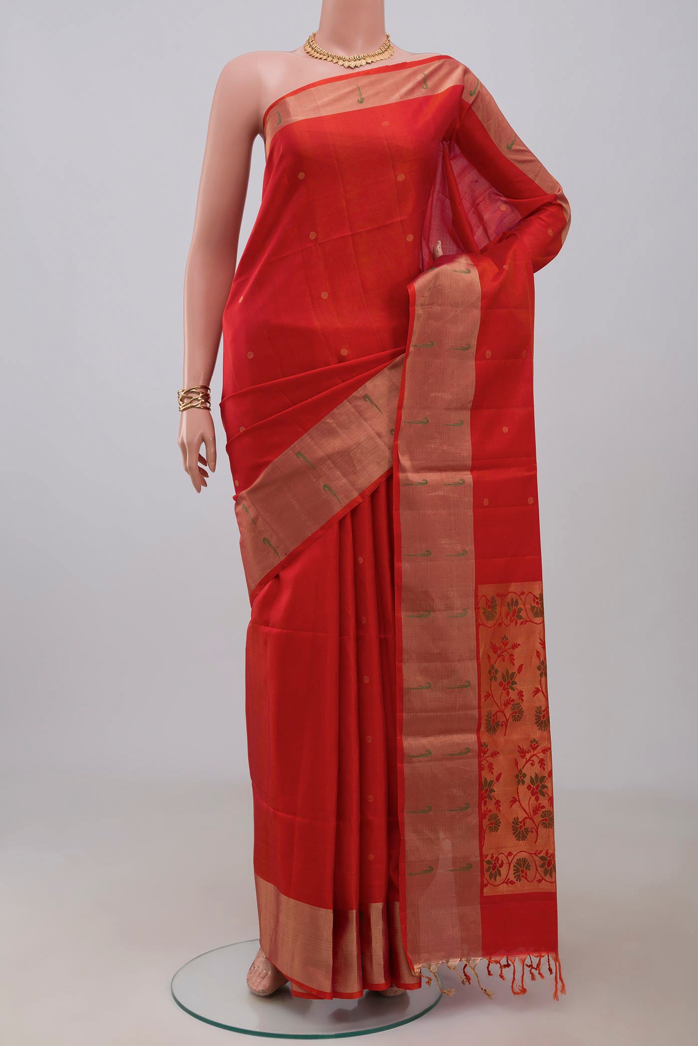 Orange Soft Silk Saree with Fancy on the body and Fancy Border.  displayed on a mannequin