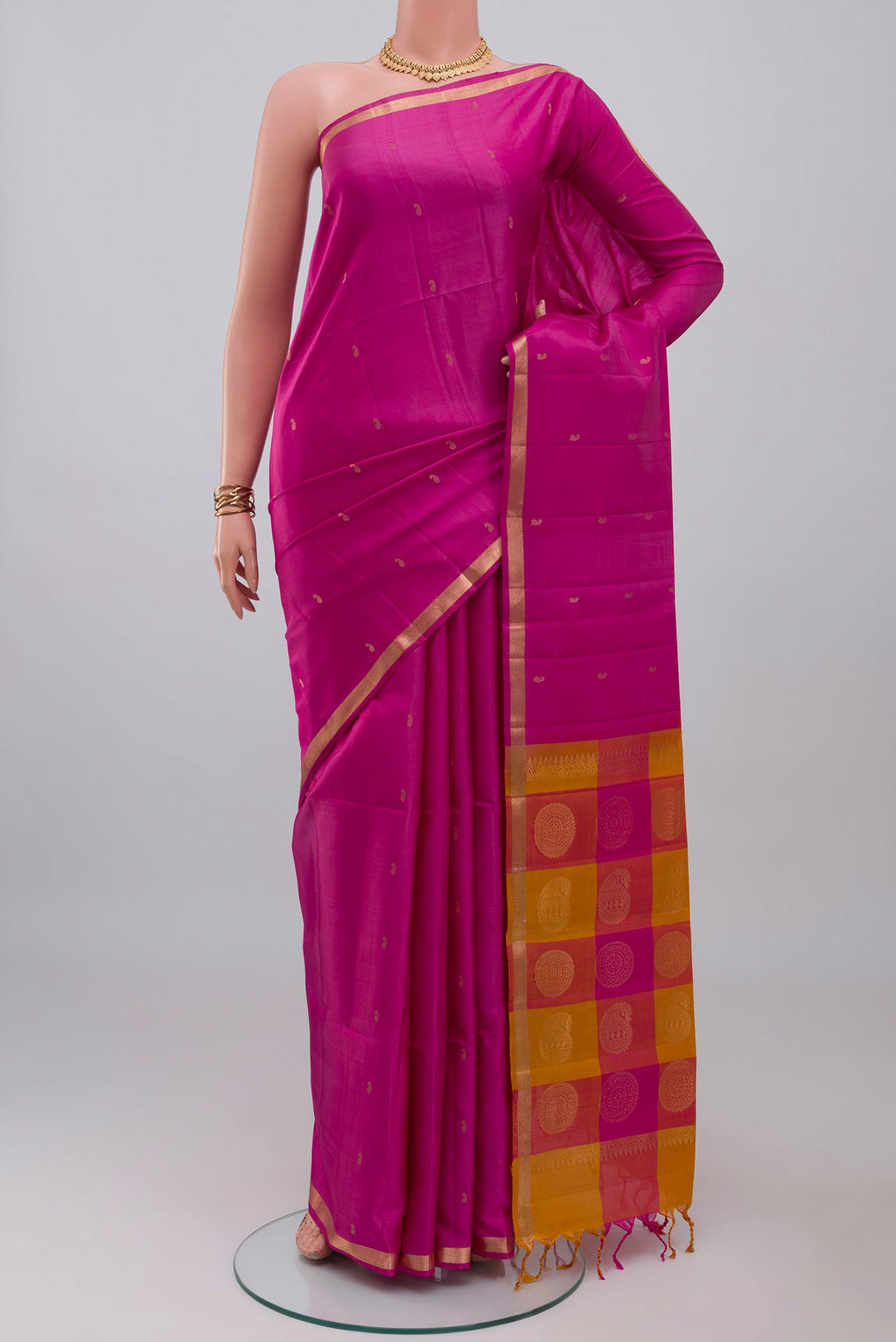 Pink Soft Silk Saree with Zari Butta on the body and Thin Zari Line.  displayed on a mannequin