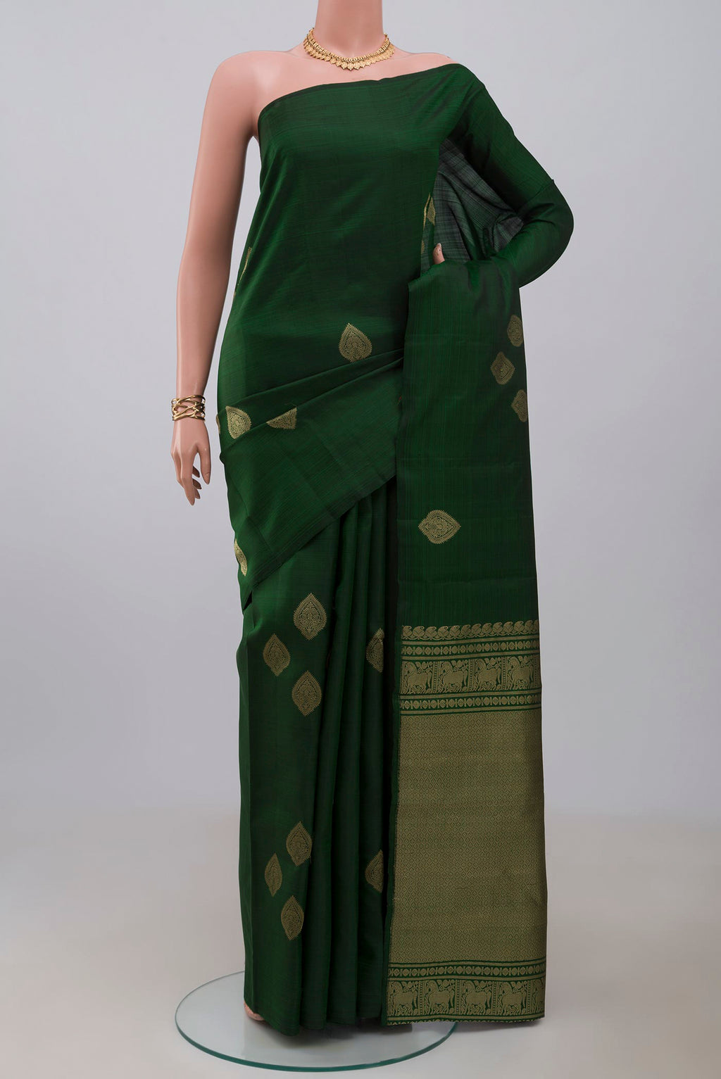 Bottle Green Kanchipuram Silk Saree with Zari Butta on the body and Without Border.  displayed on a mannequin