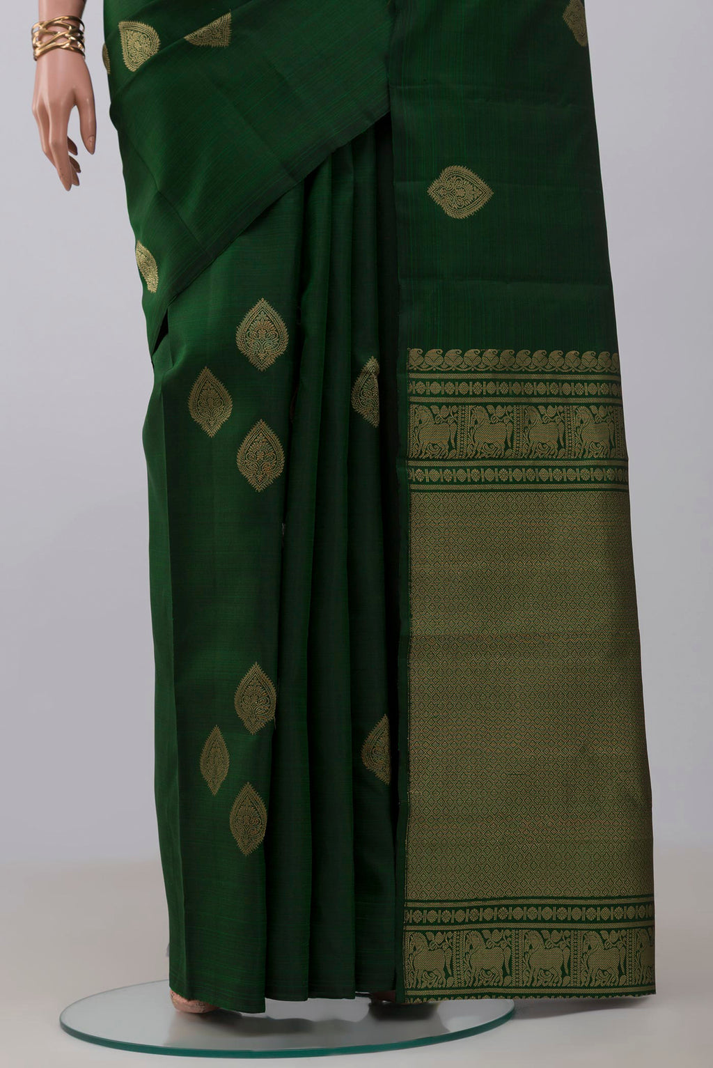 Pleats and pallu of Bottle Green Kanchipuram Silk Saree with Zari Butta on the body and Without Border. 