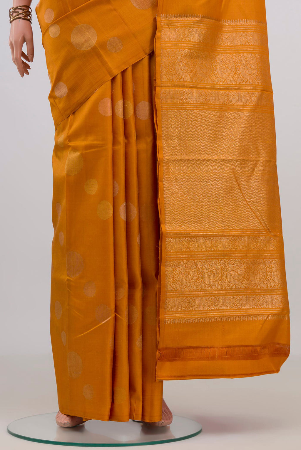 Pleats and pallu of Pure Silk Mustard Kanjivaram Saree with Zari Butta on the body and Without Border. 
