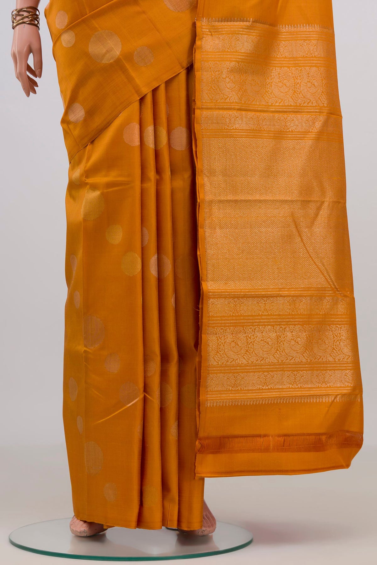 Pleats and pallu of Pure Silk Mustard Kanjivaram Saree with Zari Butta on the body and Without Border. 