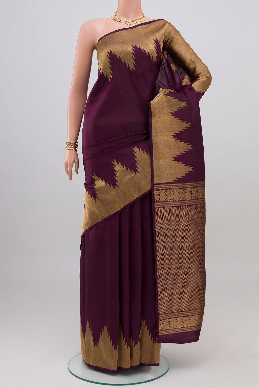 Purple Kanchipuram Silk Saree with Plain Body and Temple Border.  displayed on a mannequin