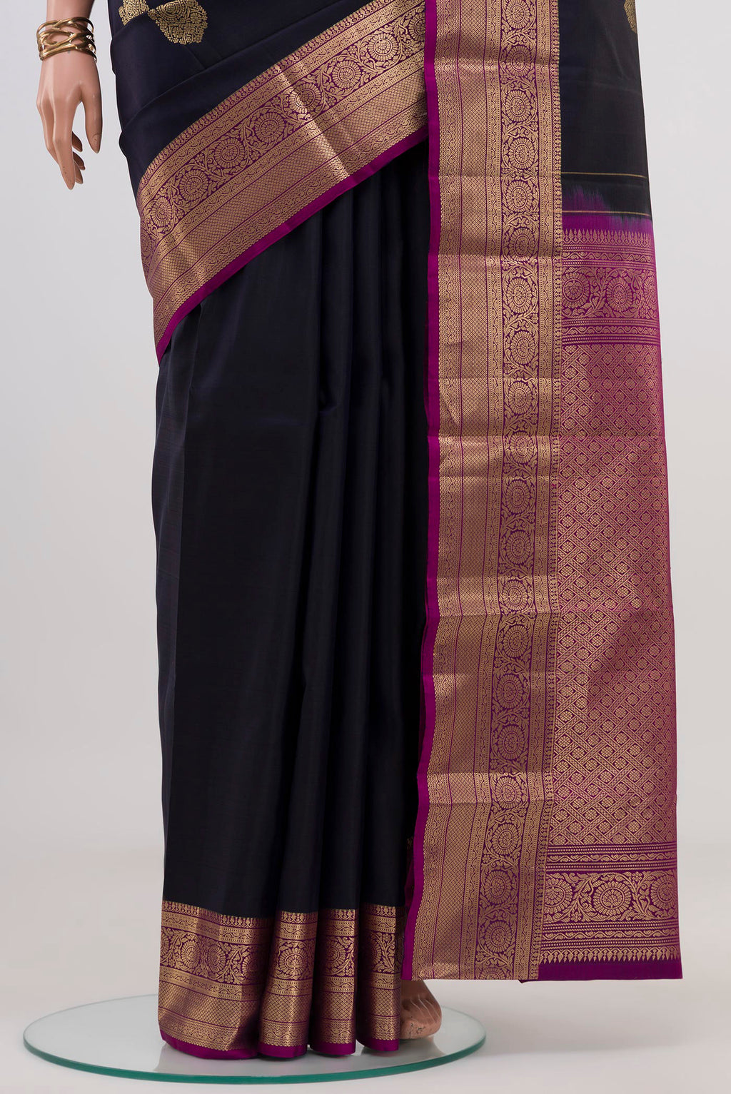 Pleats and pallu of Navy Blue Kanchipuram Silk Saree with Zari Butta on the body and Zari Border. 
