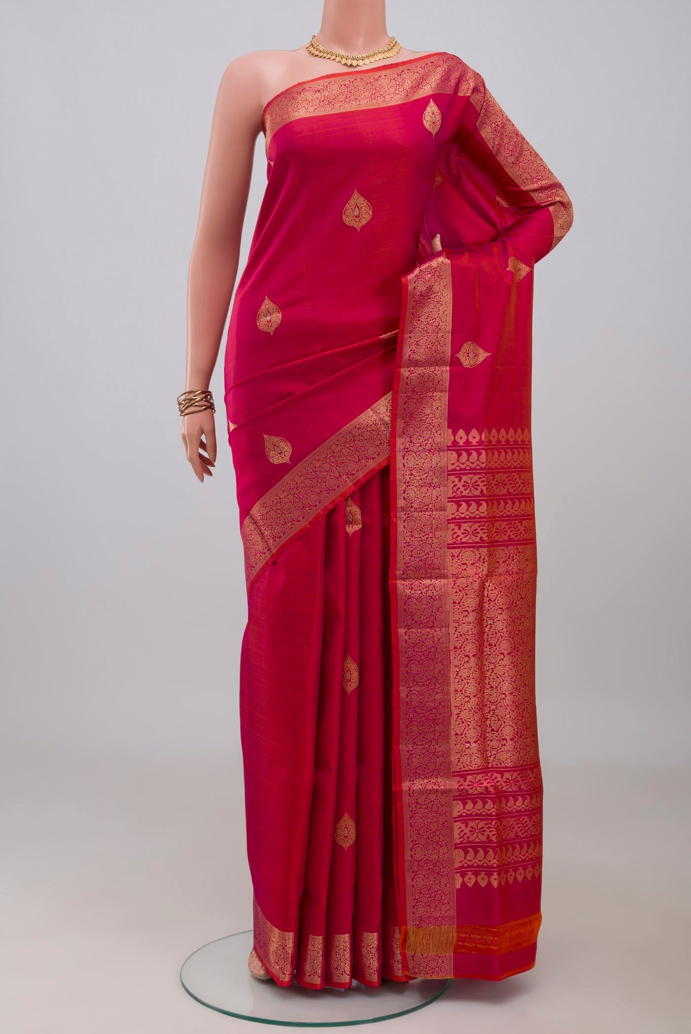 Pink Soft Silk Saree with Zari Butta on the body and Zari Border.  displayed on a mannequin