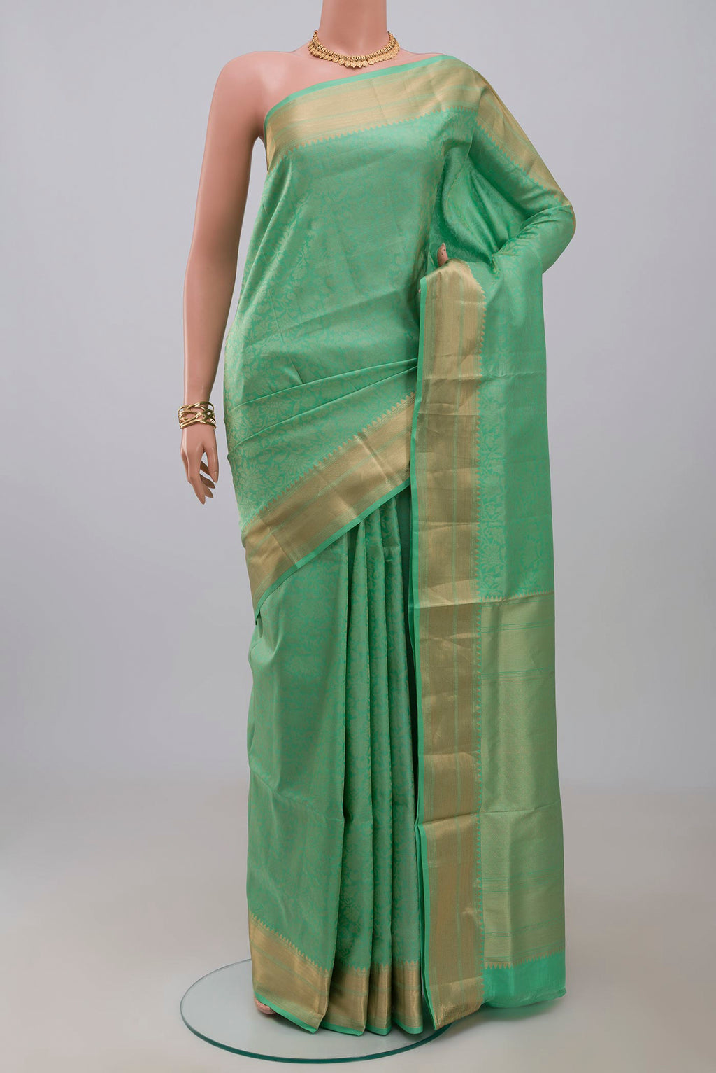 Green Soft Silk Saree with Zari Brocade on the body and Zari Border.  displayed on a mannequin