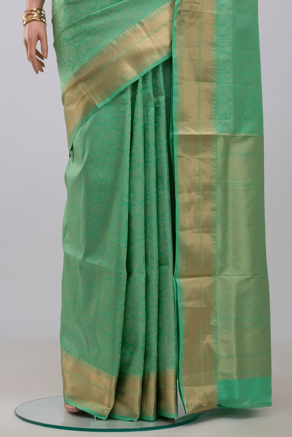Pleats and pallu of Green Soft Silk Saree with Zari Brocade on the body and Zari Border. 