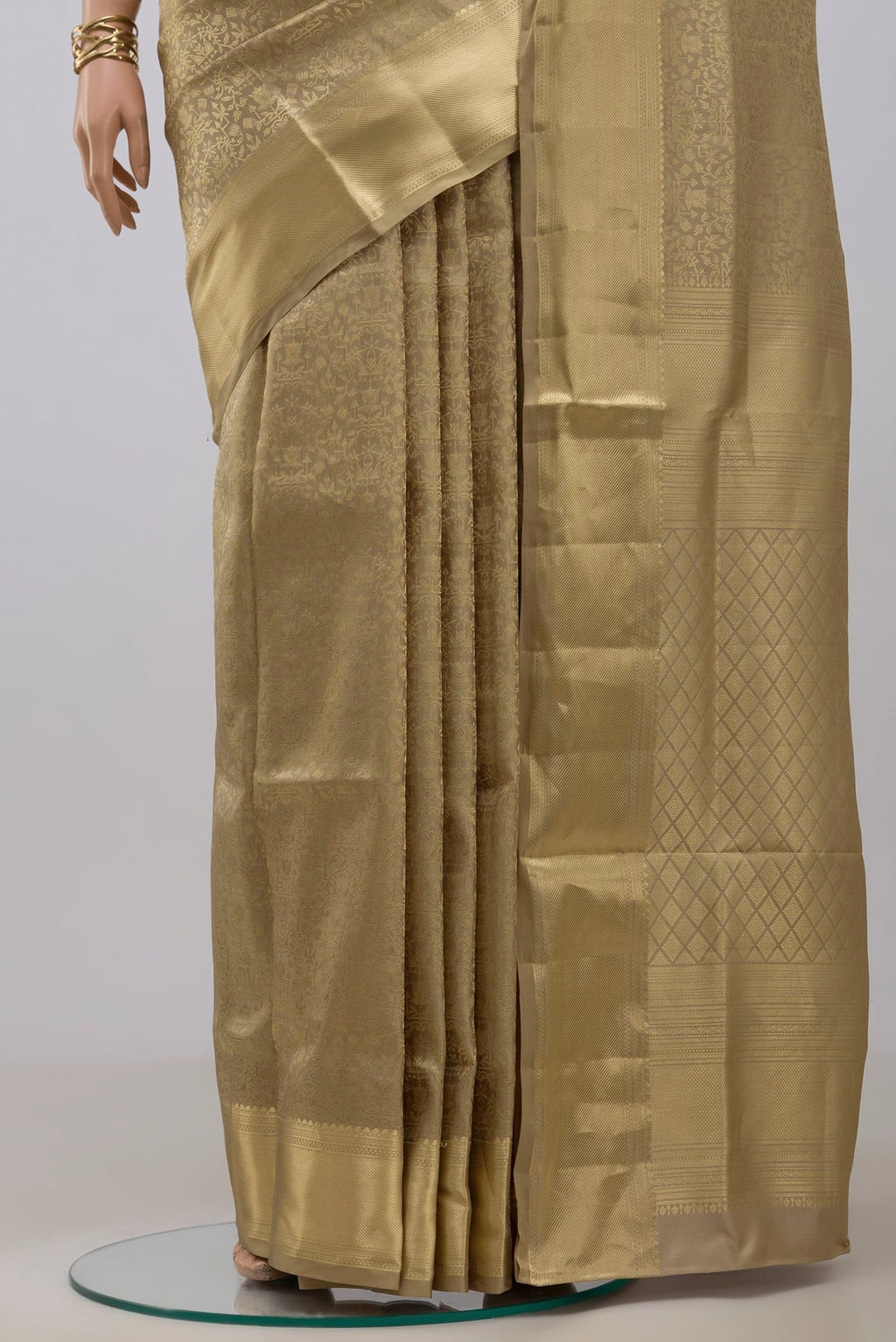 Pleats and pallu of Beige Soft Silk Saree with Zari Brocade on the body and Zari Border. 