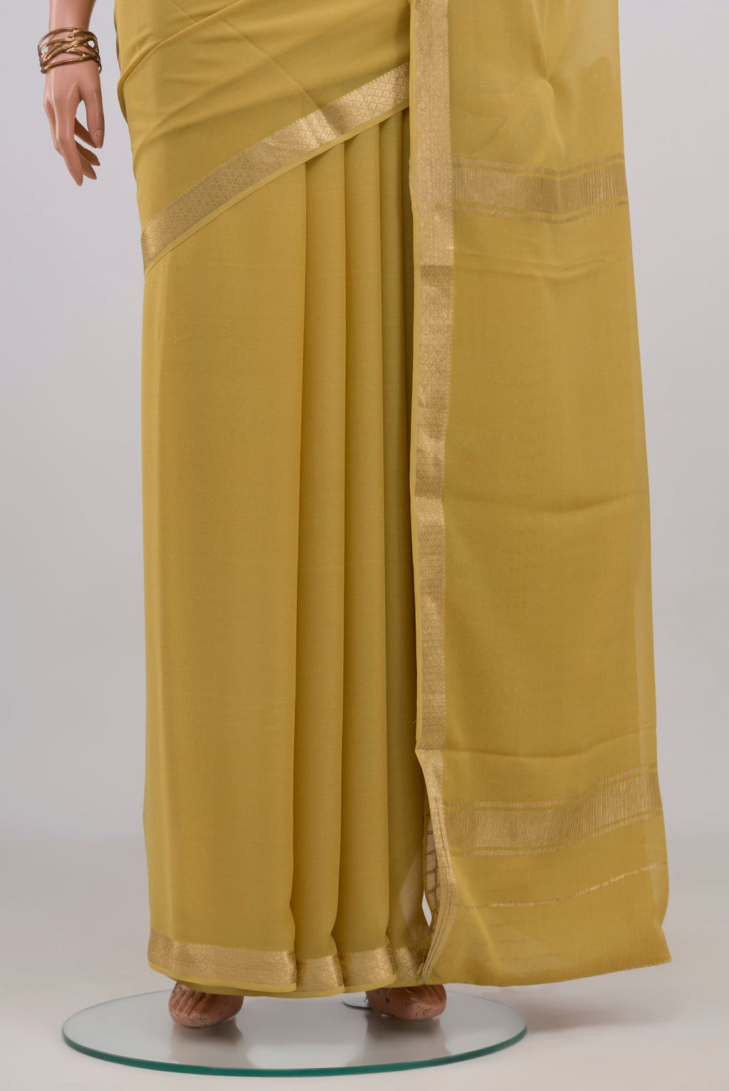 Pleats and pallu of Sandal Mysore Georgette Saree with Plain Body and Zari Border. 