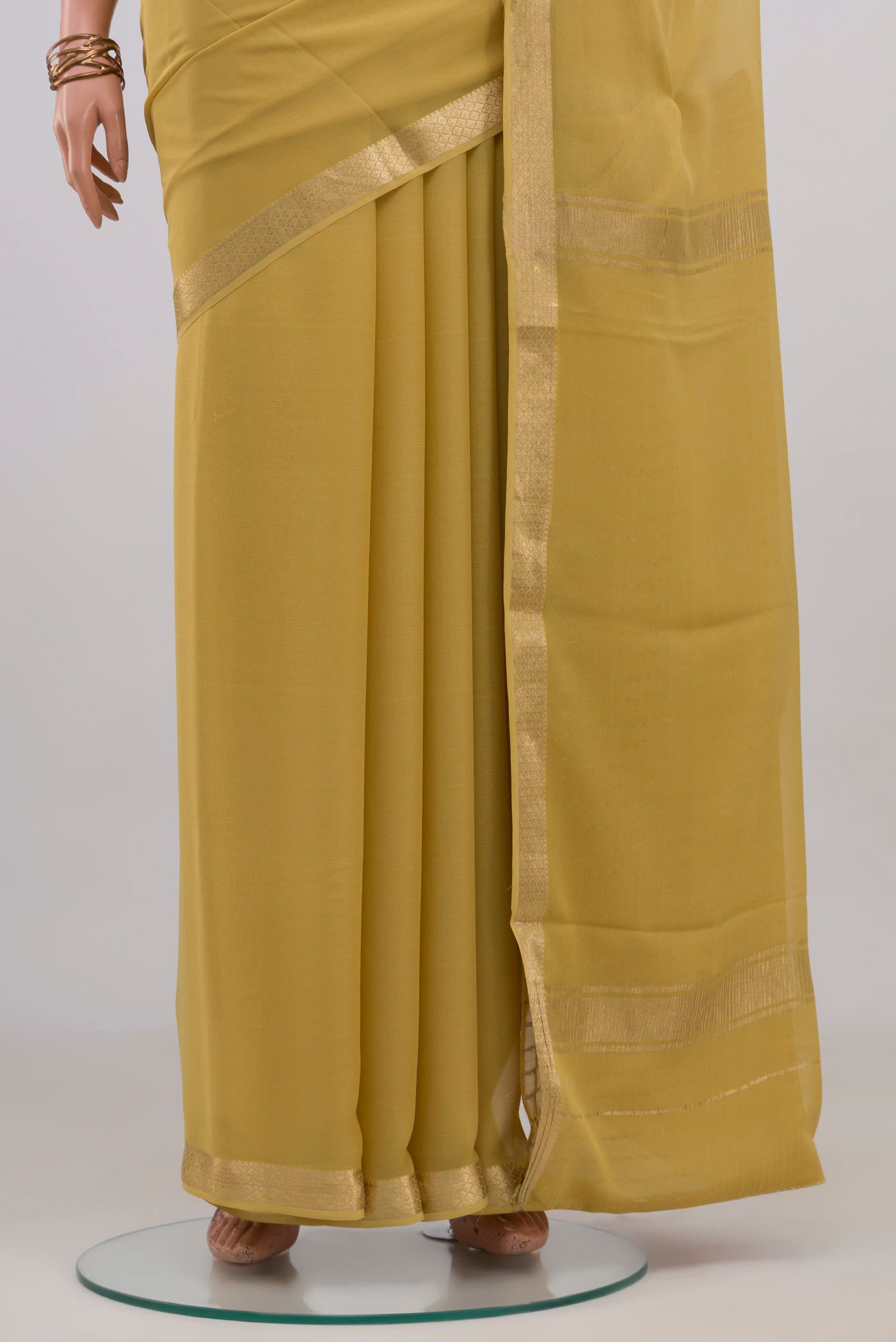 Pleats and pallu of Sandal Mysore Georgette Saree with Plain Body and Zari Border. 