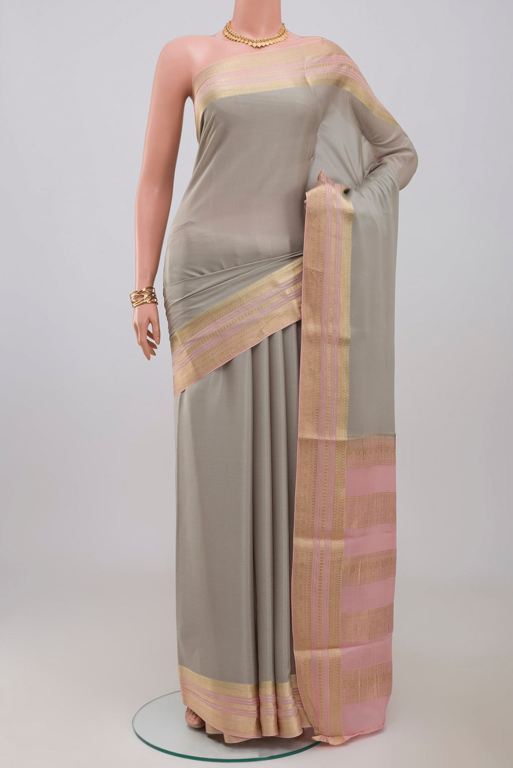 Grey Crepe Saree with Plain Body and Fancy Border.  displayed on a mannequin