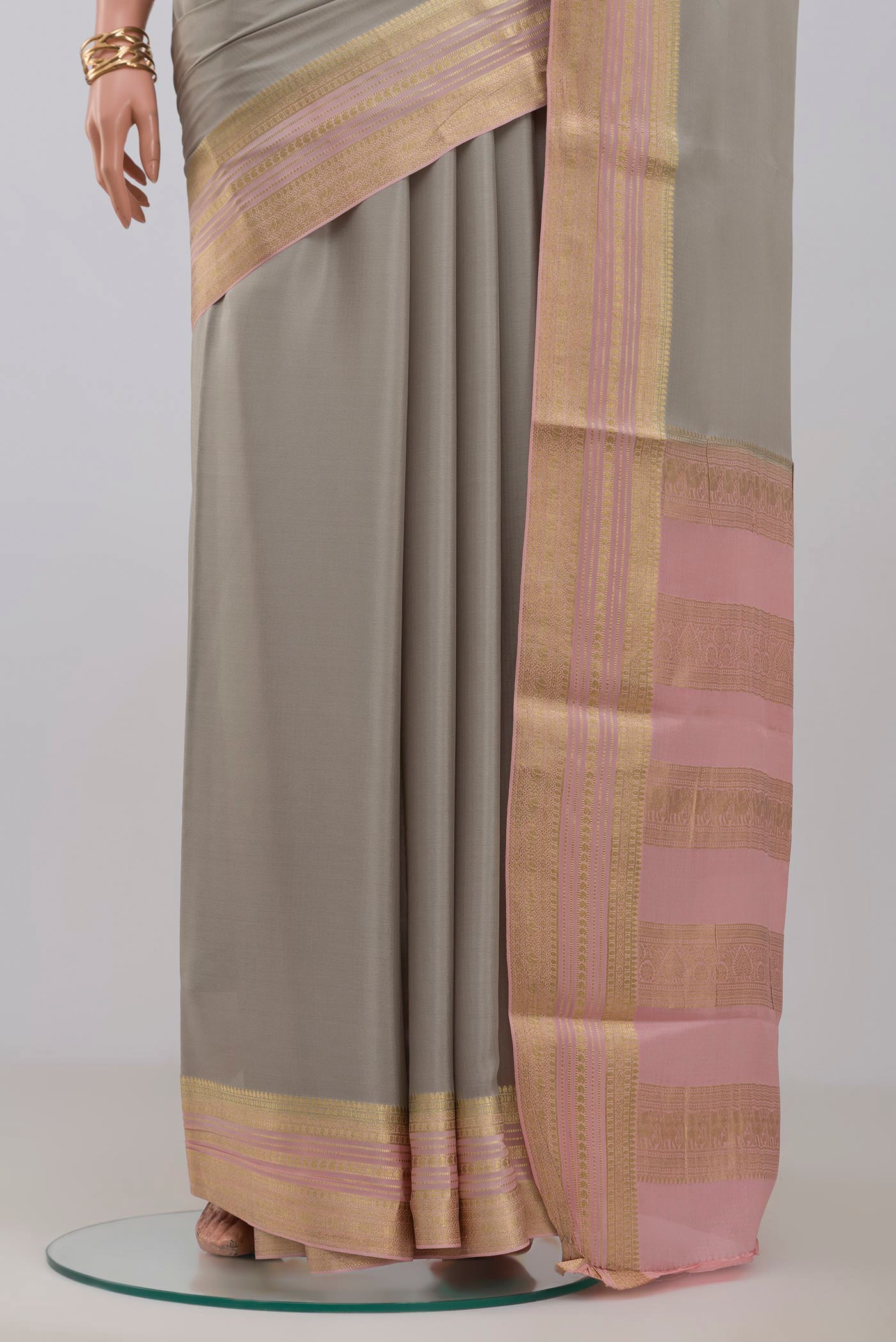 Pleats and pallu of Grey Crepe Saree with Plain Body and Fancy Border. 