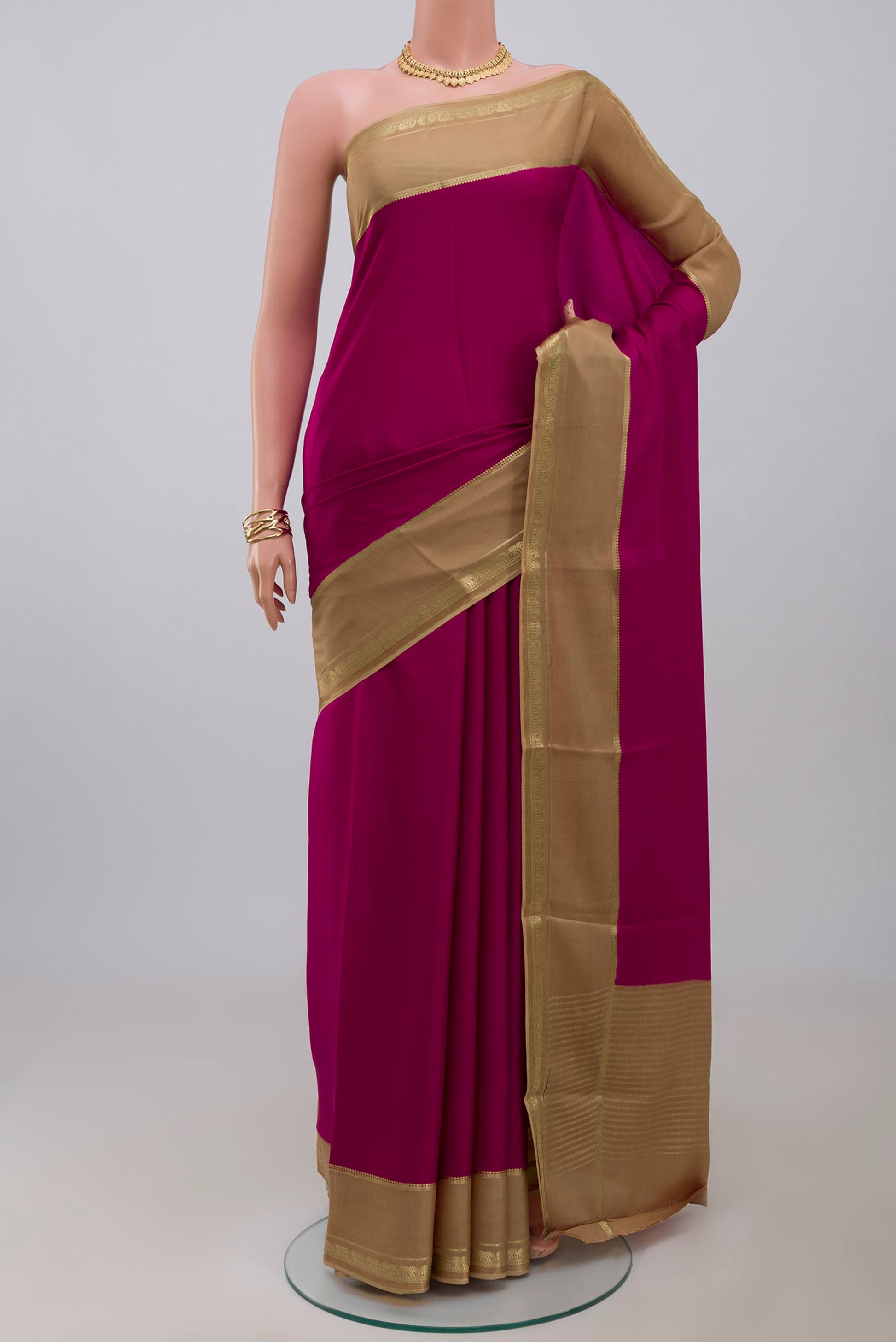 Dark Pink Mysore Crepe Saree with Plain Body and Zari Border.  displayed on a mannequin