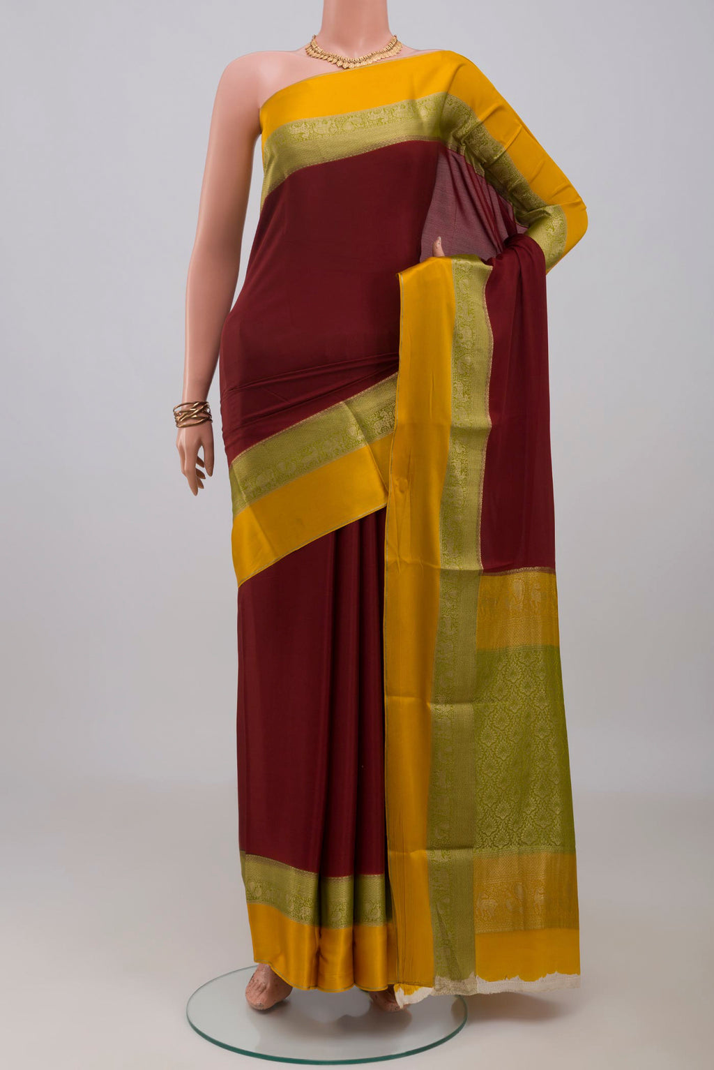 Maroon Mysore Crepe Saree with Plain Body and Zari Border.  displayed on a mannequin
