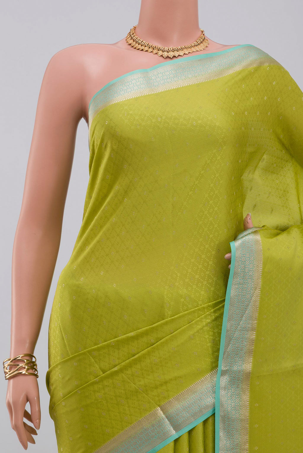 Border image of Parrot Green Crepe Saree with Fancy on the body and Zari Border. 