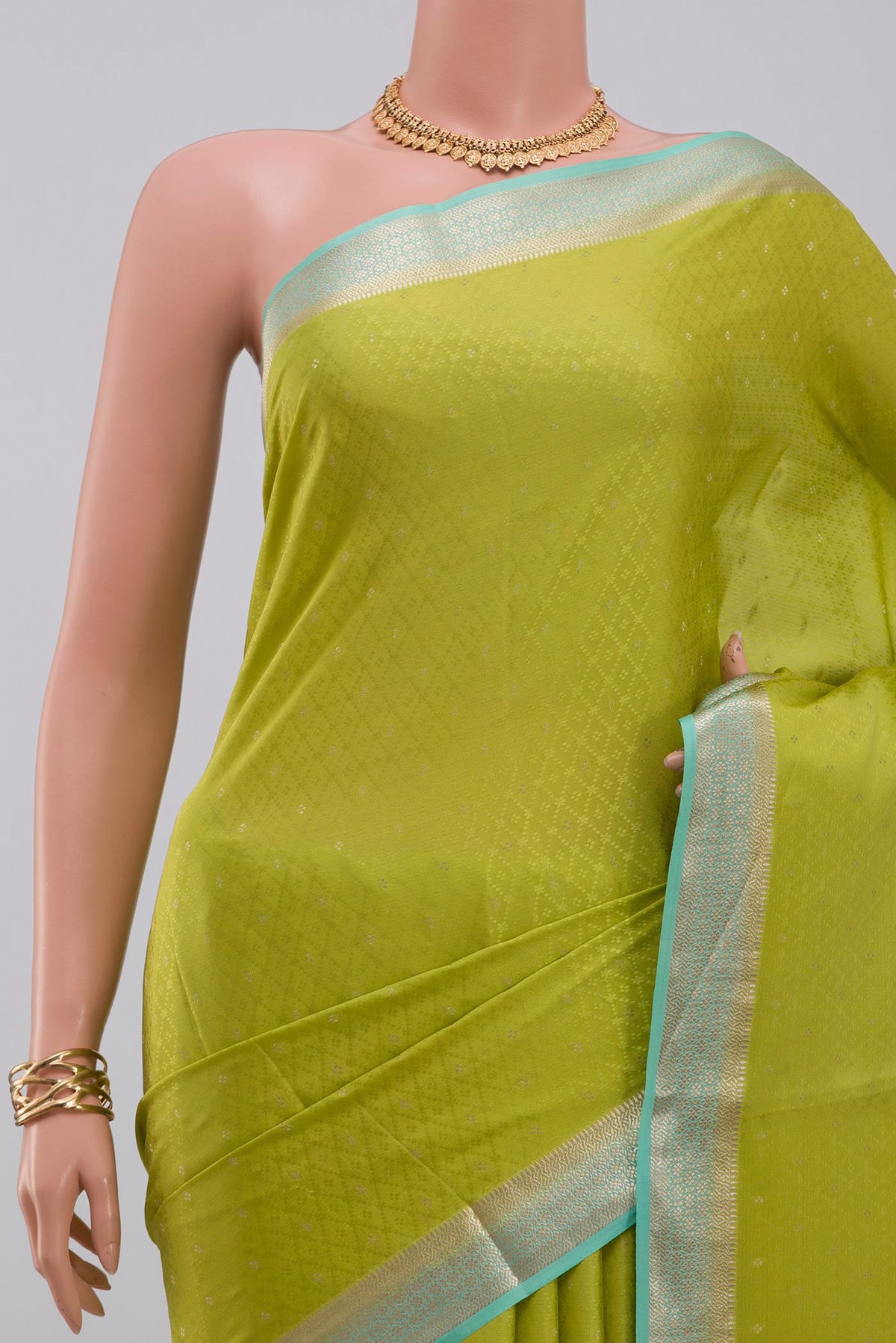 Border image of Parrot Green Crepe Saree with Fancy on the body and Zari Border. 
