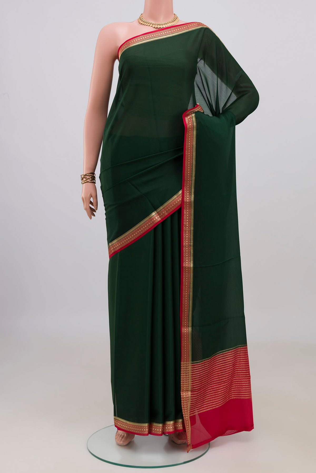 Bottle Green Mysore Crepe Saree with Plain Body and Zari Border.  displayed on a mannequin