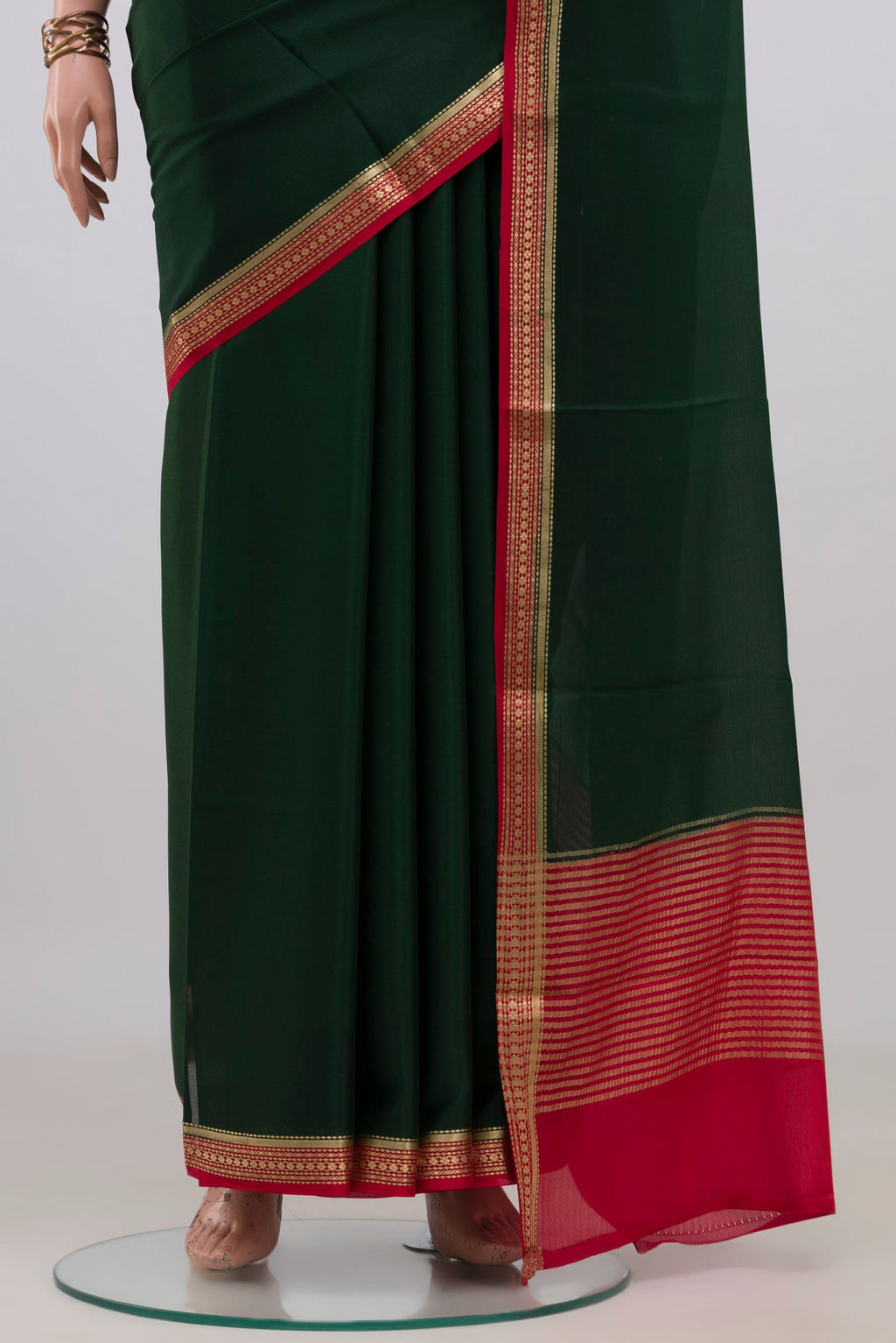 Pleats and pallu of Bottle Green Mysore Crepe Saree with Plain Body and Zari Border. 
