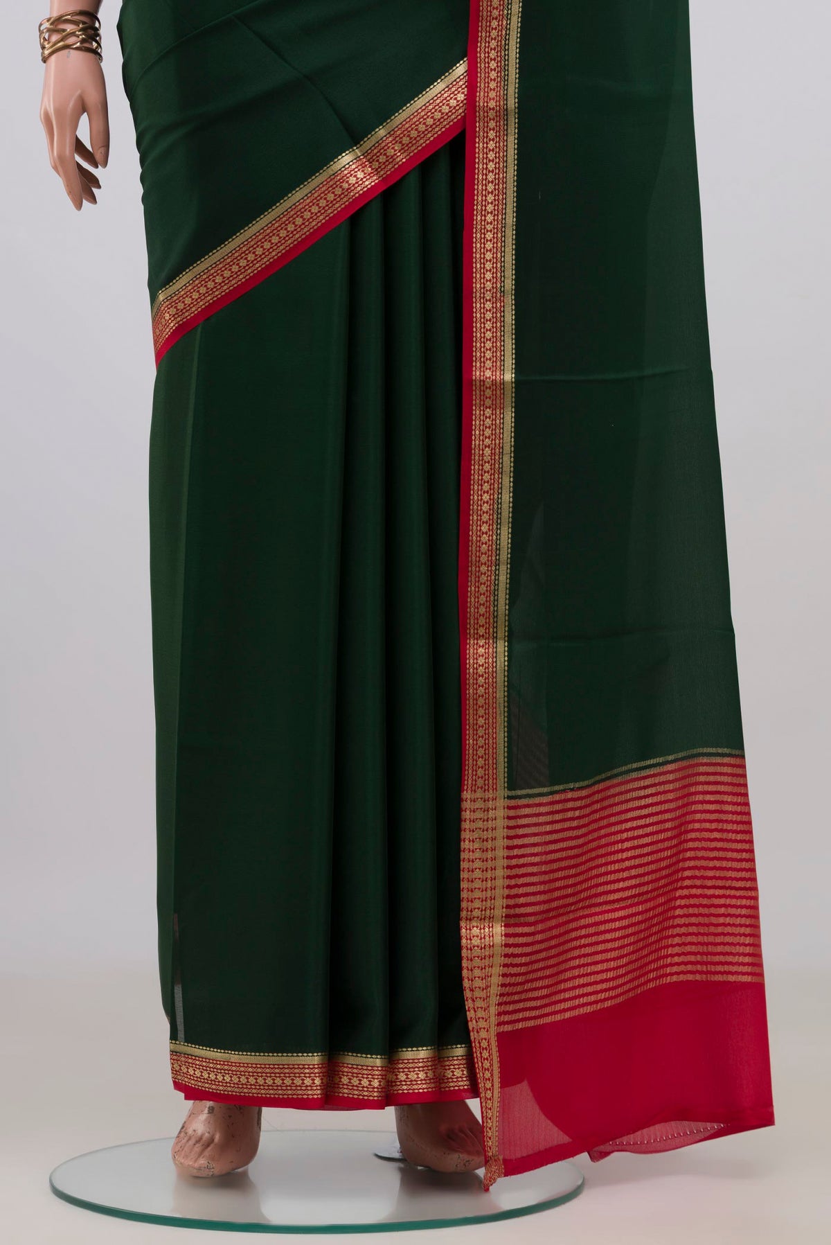 Pleats and pallu of Bottle Green Mysore Crepe Saree with Plain Body and Zari Border. 