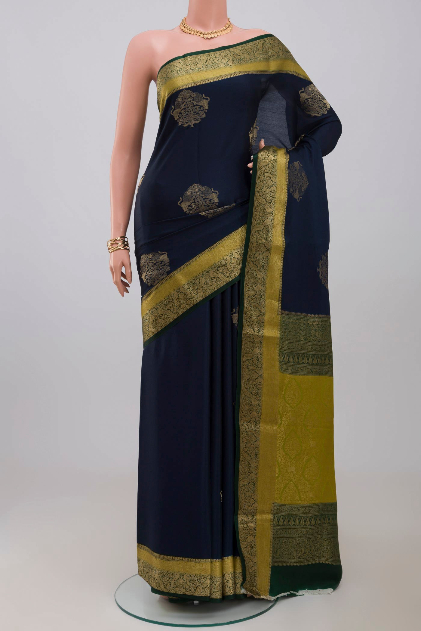 Blue Crepe Saree with Zari Butta on the body and Fancy Border.  displayed on a mannequin