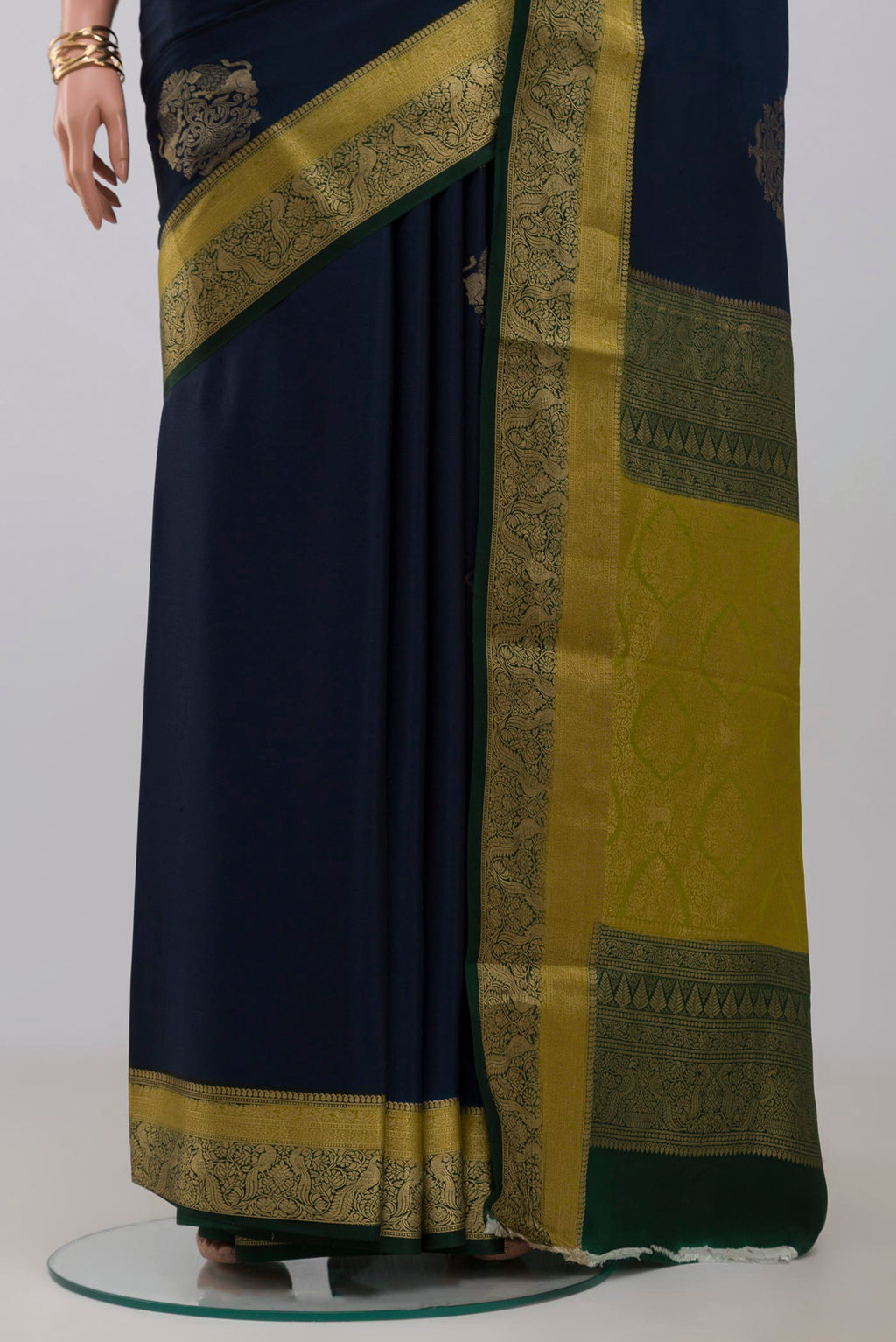 Pleats and pallu of Blue Crepe Saree with Zari Butta on the body and Fancy Border. 
