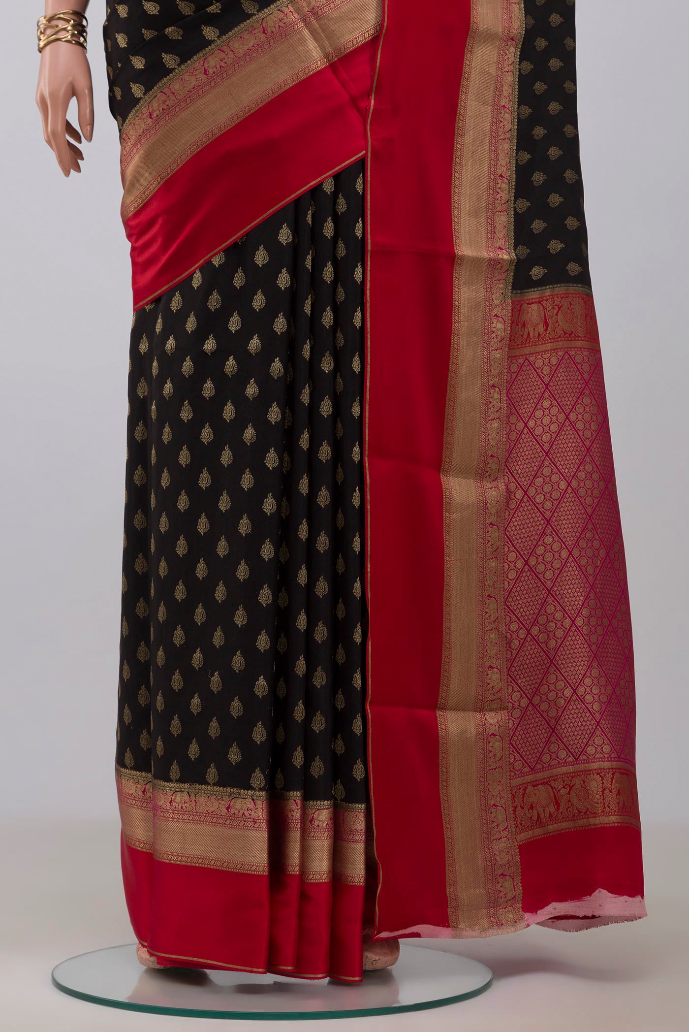 Pleats and pallu of Black Crepe Saree with Zari Butta on the body and Zari Border. 