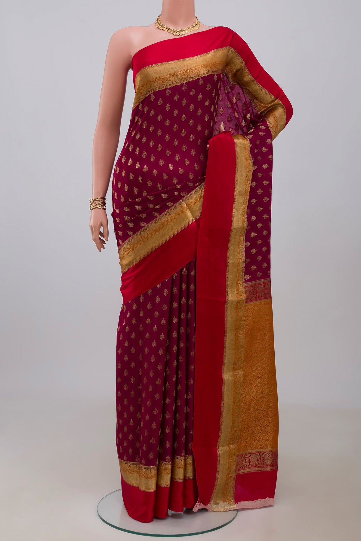 Purple Crepe Saree with Zari Butta on the body and Zari Border.  displayed on a mannequin