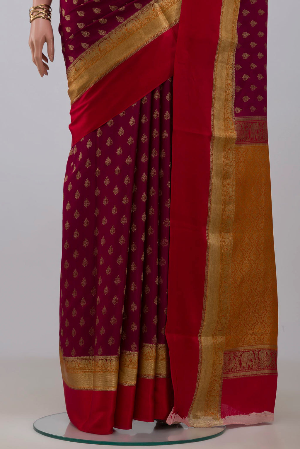 Pleats and pallu of Purple Crepe Saree with Zari Butta on the body and Zari Border. 