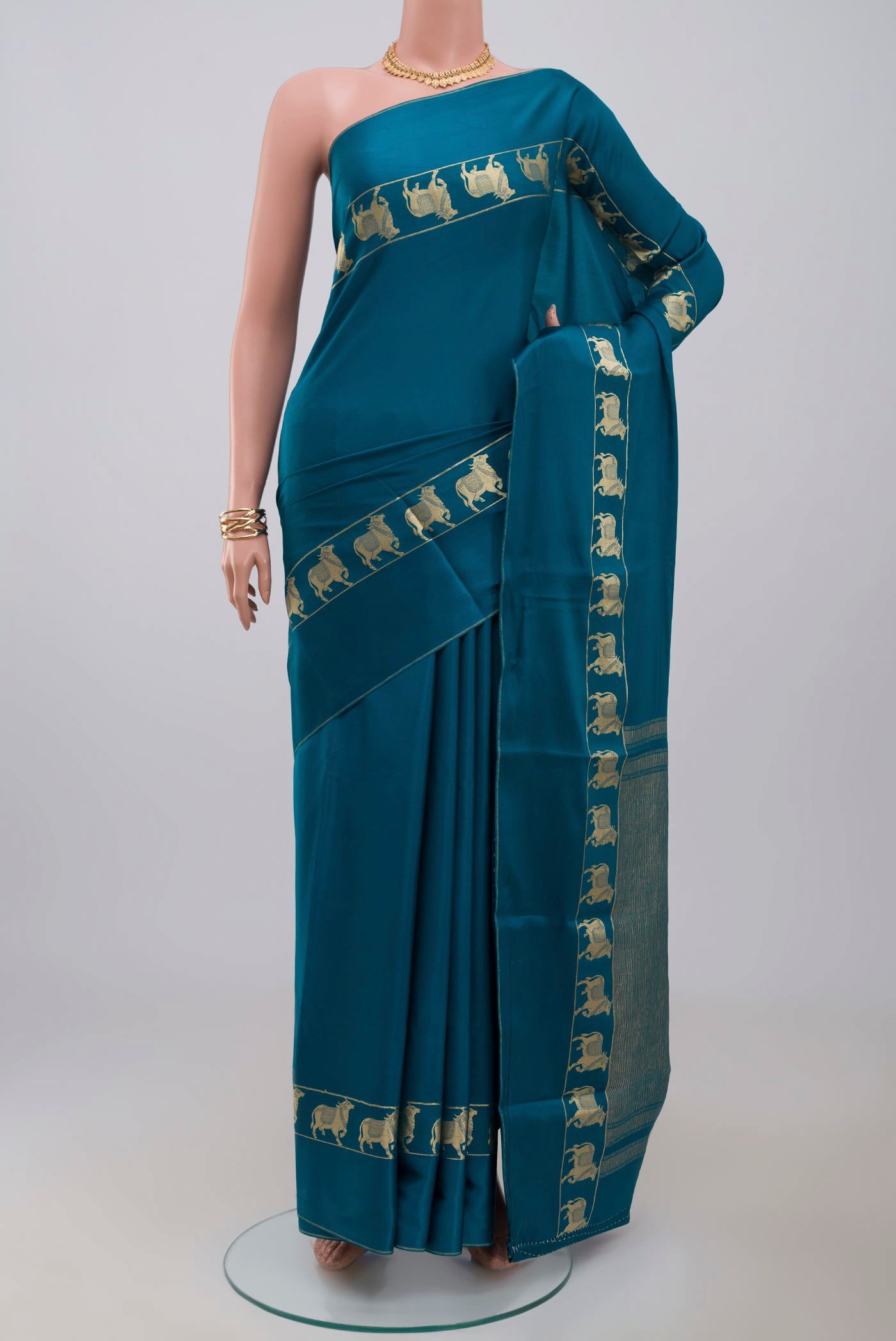 Blue Crepe Saree with Plain Body and Zari Border.  displayed on a mannequin