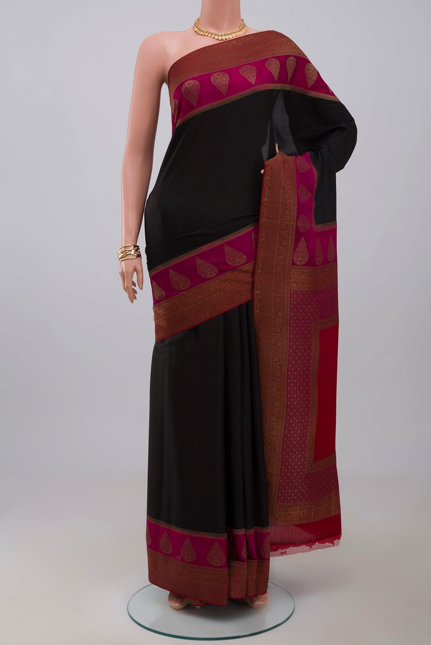 Black Crepe Saree with Plain Body and Zari Border.  displayed on a mannequin