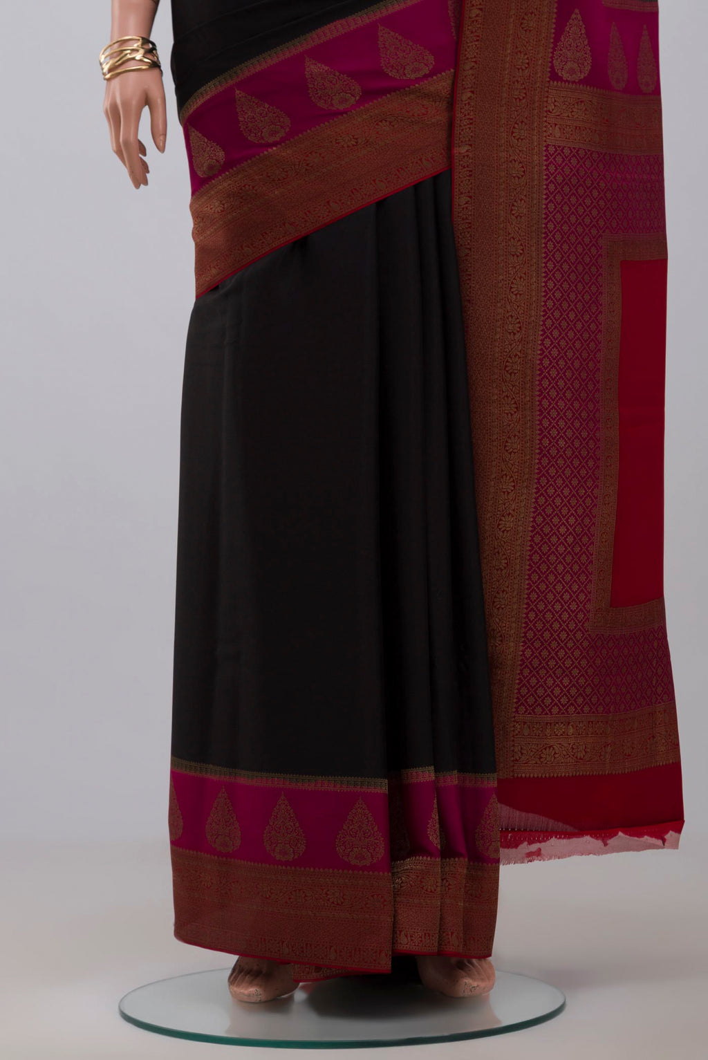 Pleats and pallu of Black Crepe Saree with Plain Body and Zari Border. 